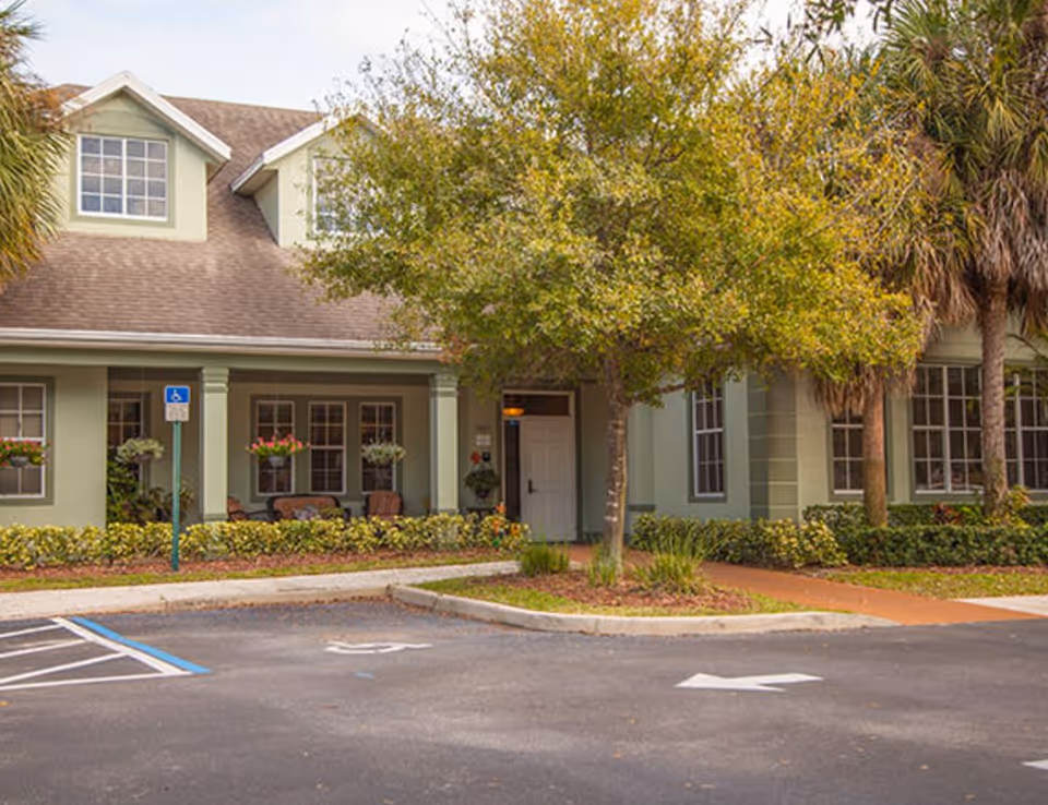 Exterior view of Brookdale Stuart building entrance with landscaping and parking.