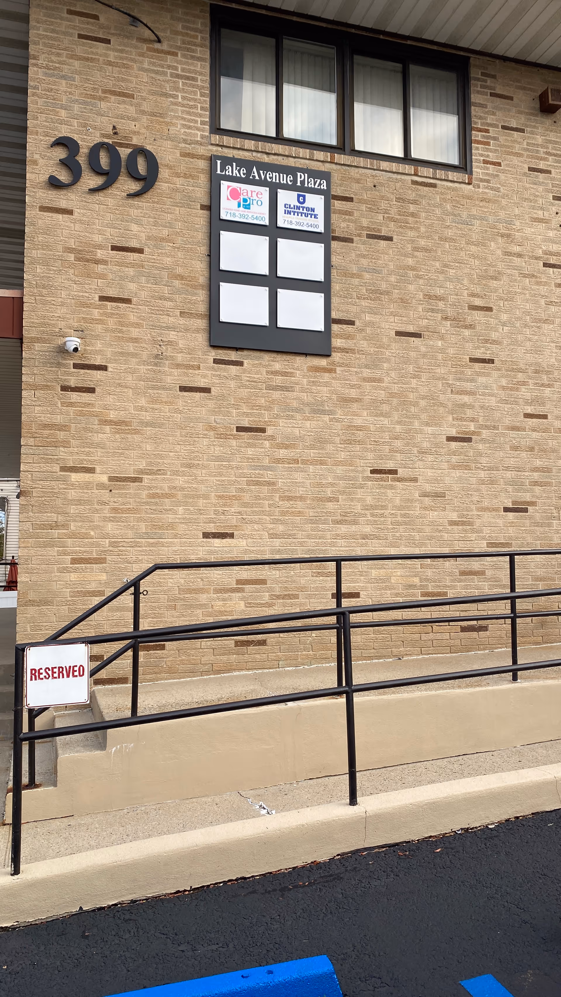 Brick building facade with 399 address, CarePro sign, and a wheelchair ramp.