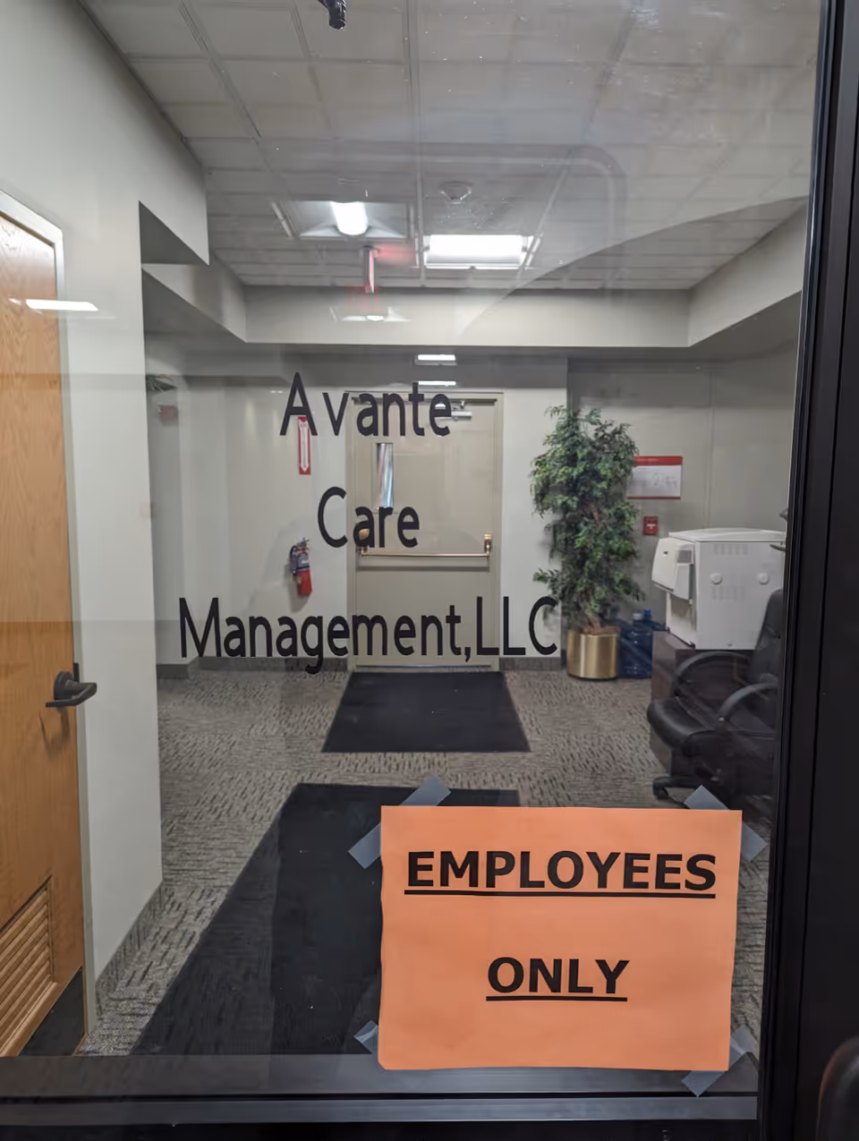 Glass door shows Avante Care Management, LLC; orange Employees Only sign in the lobby.