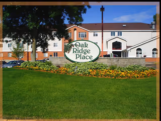 Oak Ridge Place exterior with sign, building, and well-kept lawn.