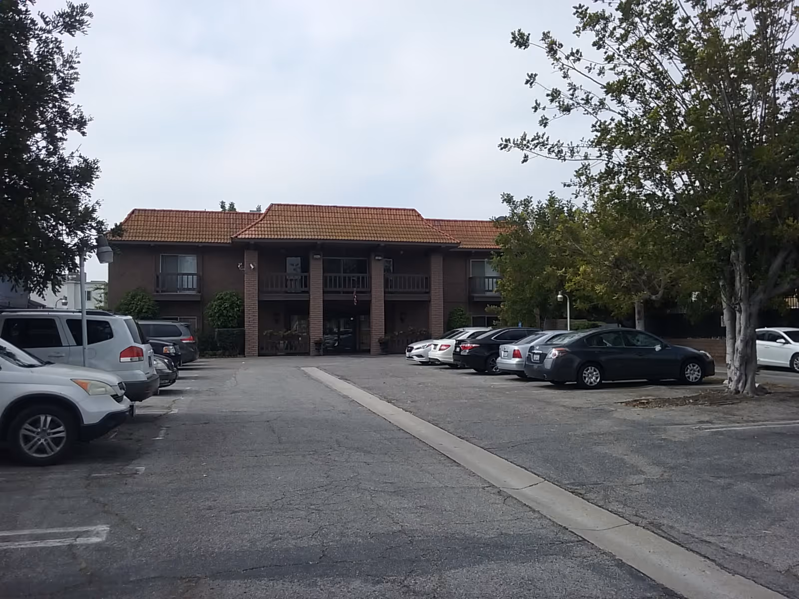 Exterior view of Westchester Villa, a brick two-story building with a parking lot.