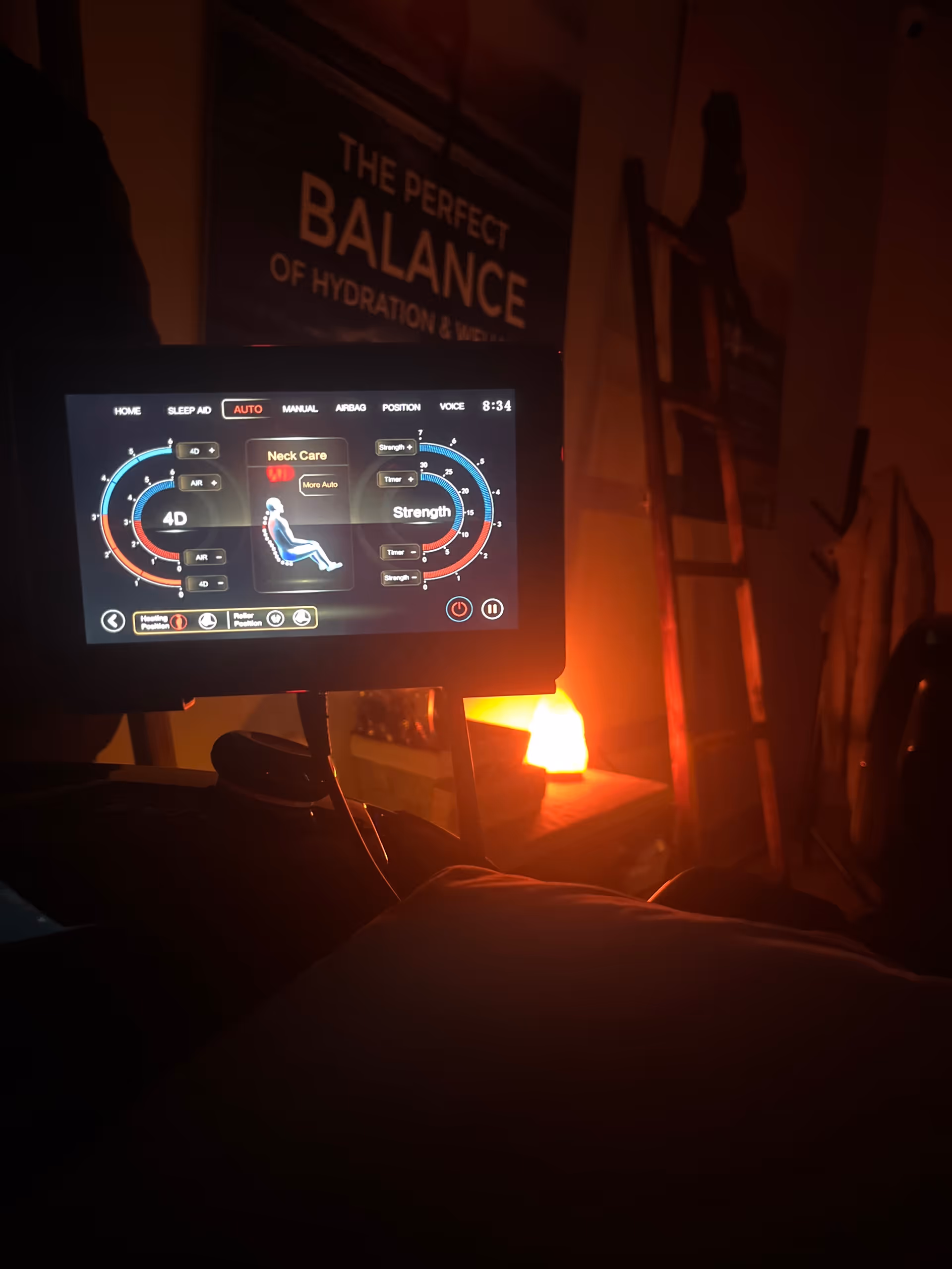 Dimly lit interior with a hydration device screen and a balance sign in background.