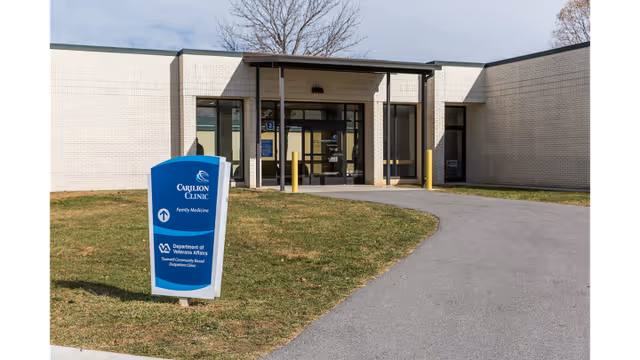 Front view of a medical facility entrance with a blue Carilion Clinic sign.