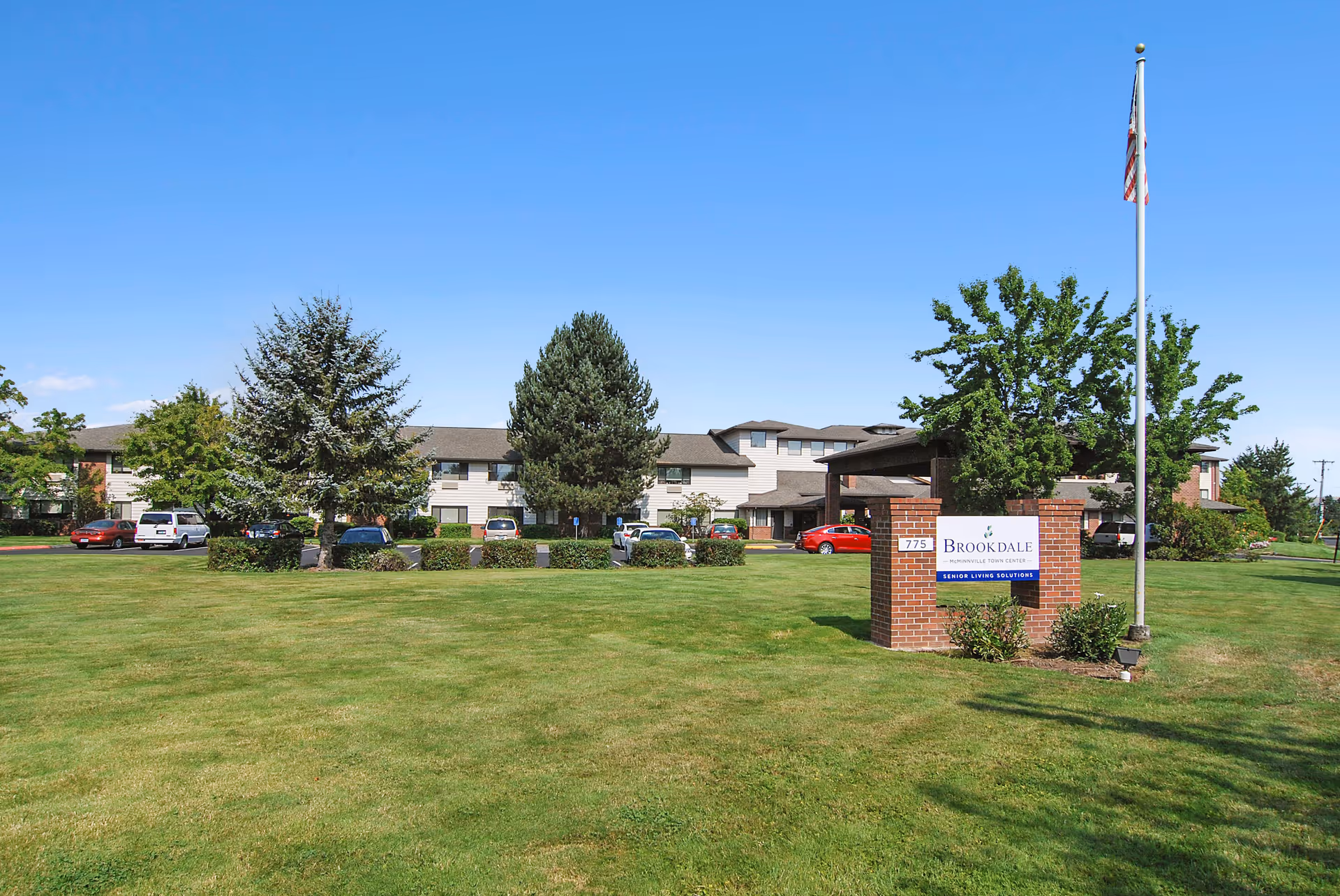 Exterior view of Brookdale McMinnville Town Center with manicured lawn and signage.