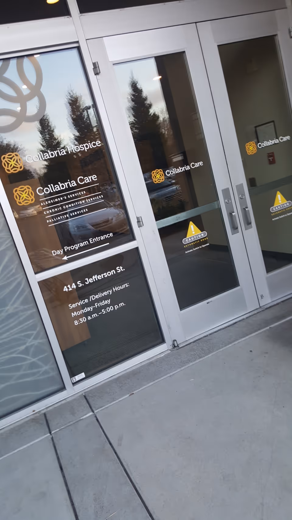 Glass entrance doors with Collabria Care logos and Day Program Entrance signage