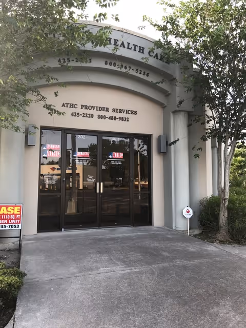 Entrance of All Texas Health Care facility with glass doors and signage