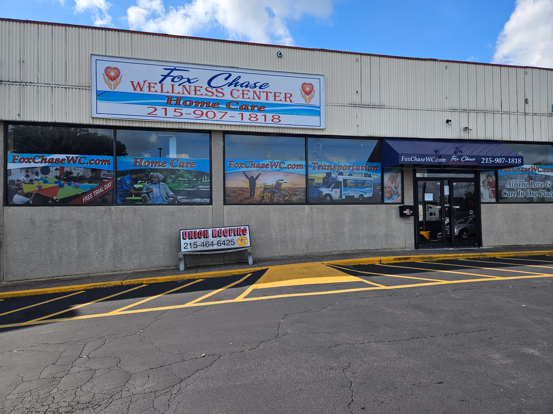 Exterior storefront of Fox Chase Wellness Center Home Care with large sign and windows.