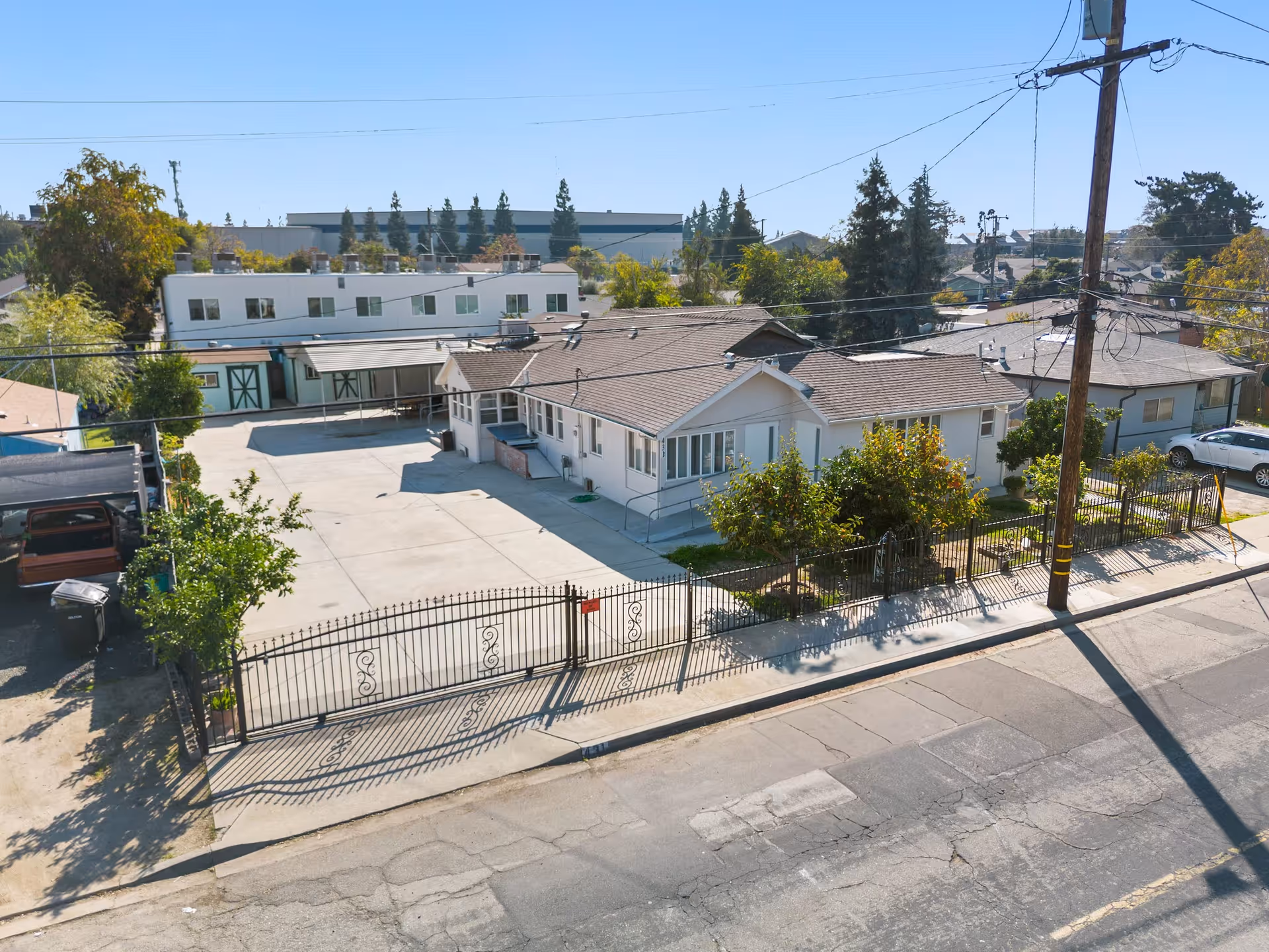 A single-story senior care facility with a gated front yard and driveway along a residential street.
