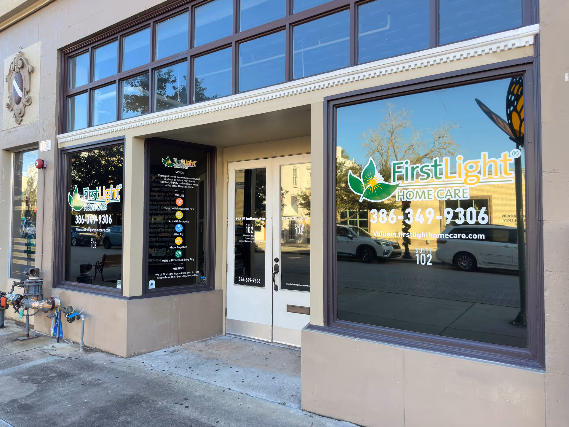 Storefront of FirstLight Home Care with large windows and signage.