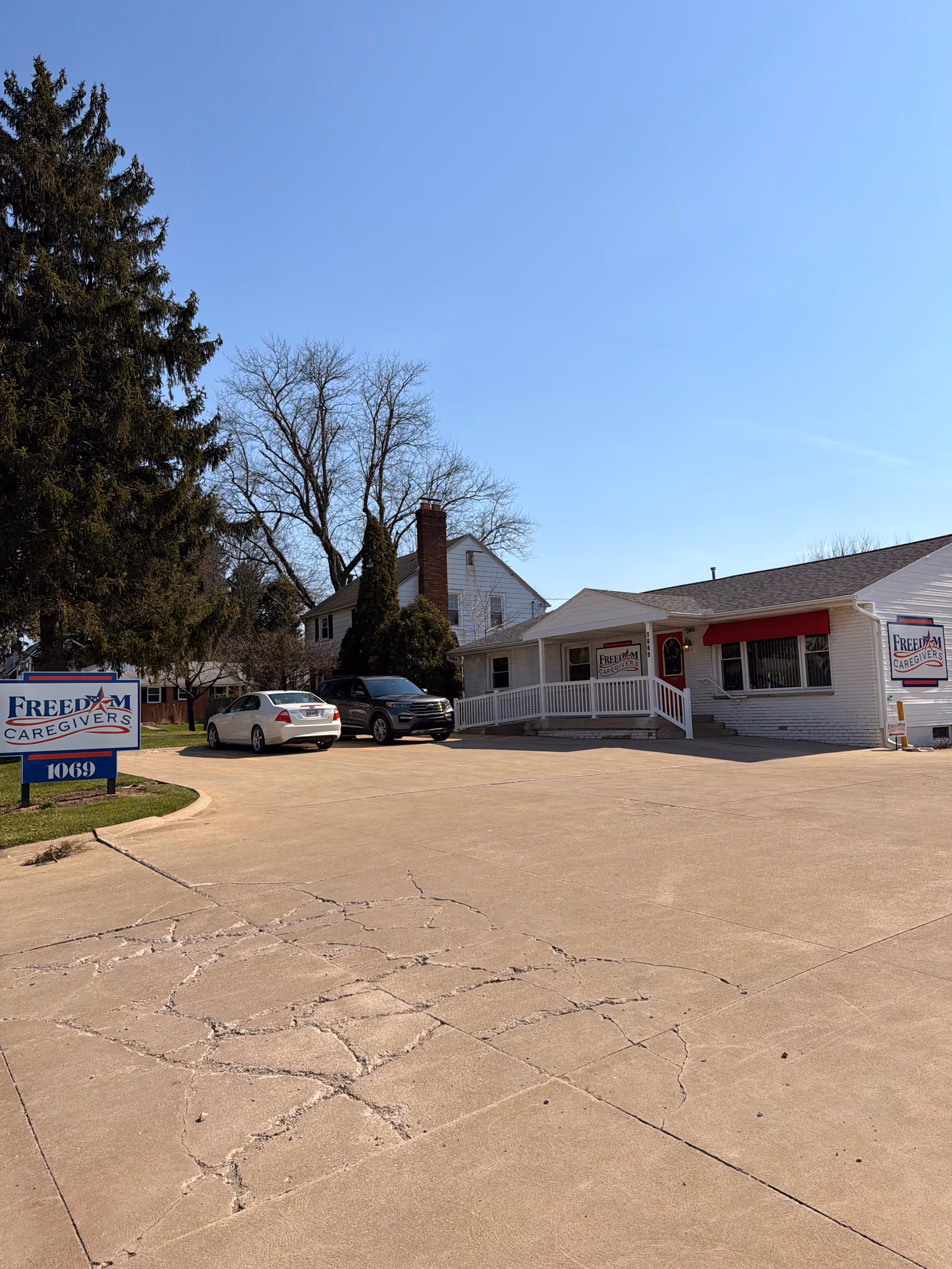Exterior view of Freedom Caregivers-Mansfield facility with cars in the parking lot