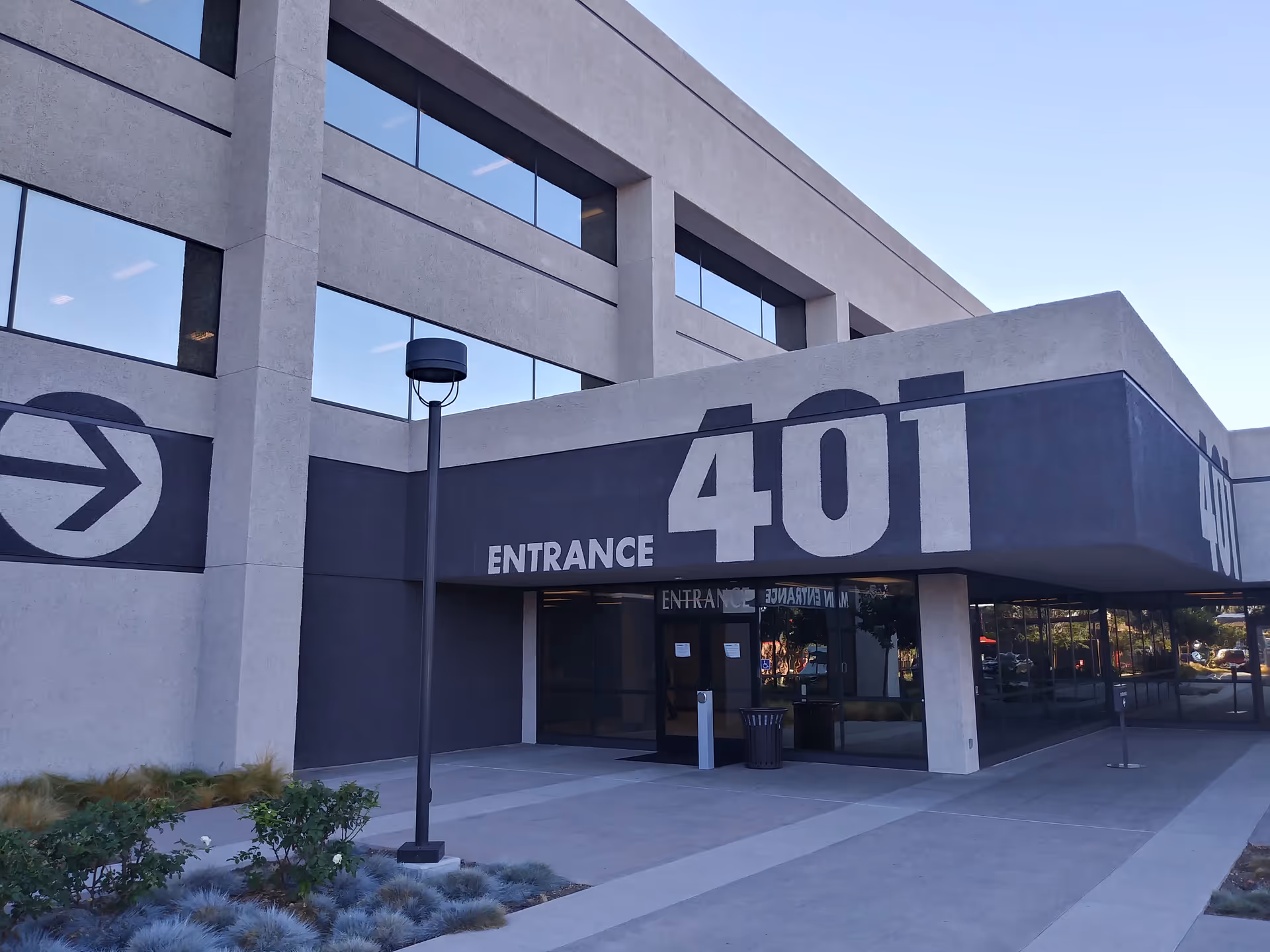 Exterior view of a modern building entrance with a large 401 sign