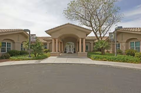 Exterior view of Brookdale Tanque Verde entrance with columns and landscaped front.