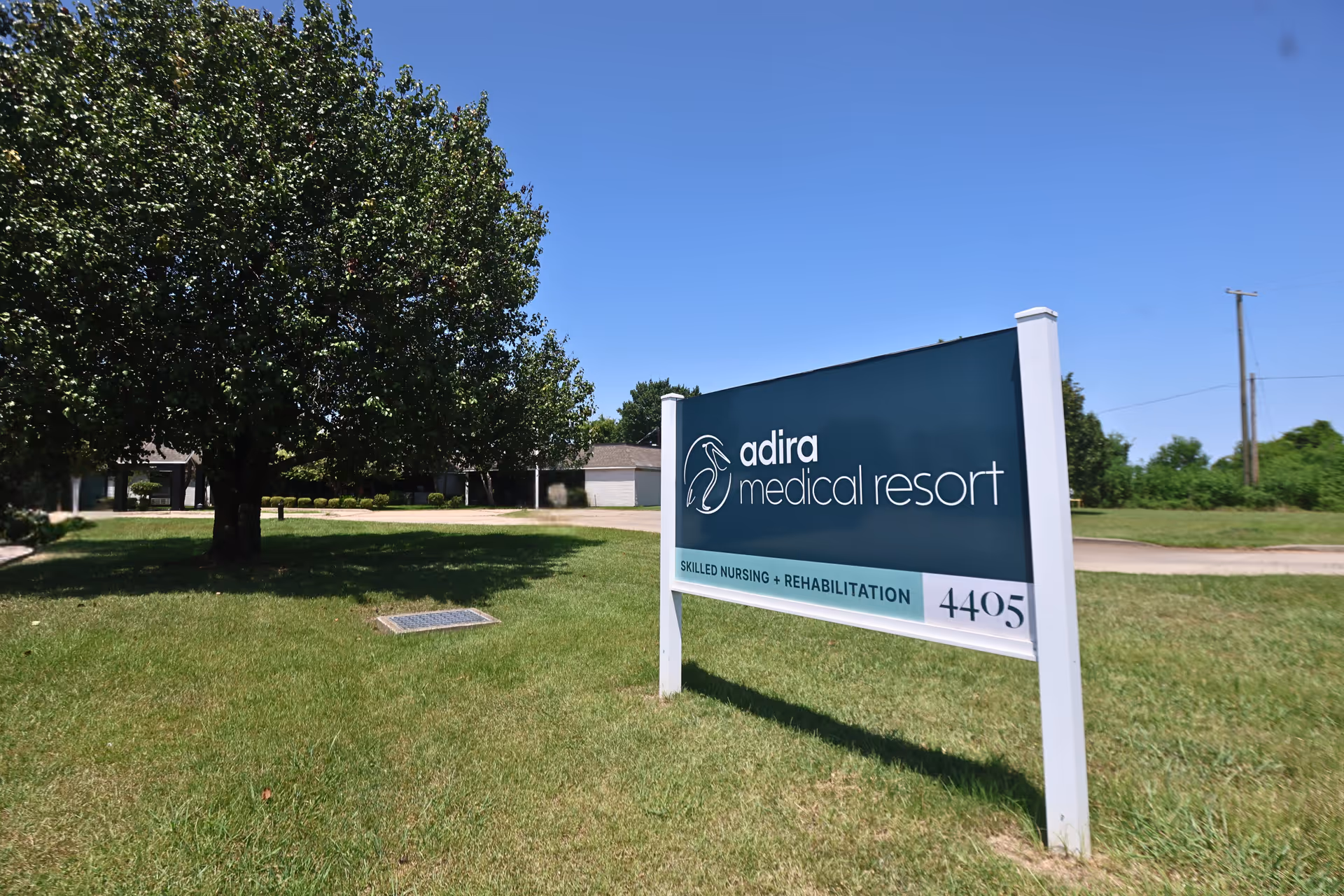 Exterior view of a grassy front with a sign reading Adira medical resort.