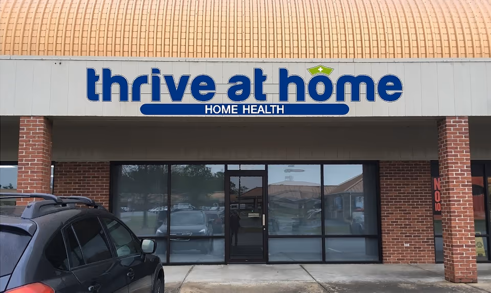 Front view of Thrive at Home building with sign and glass entrance