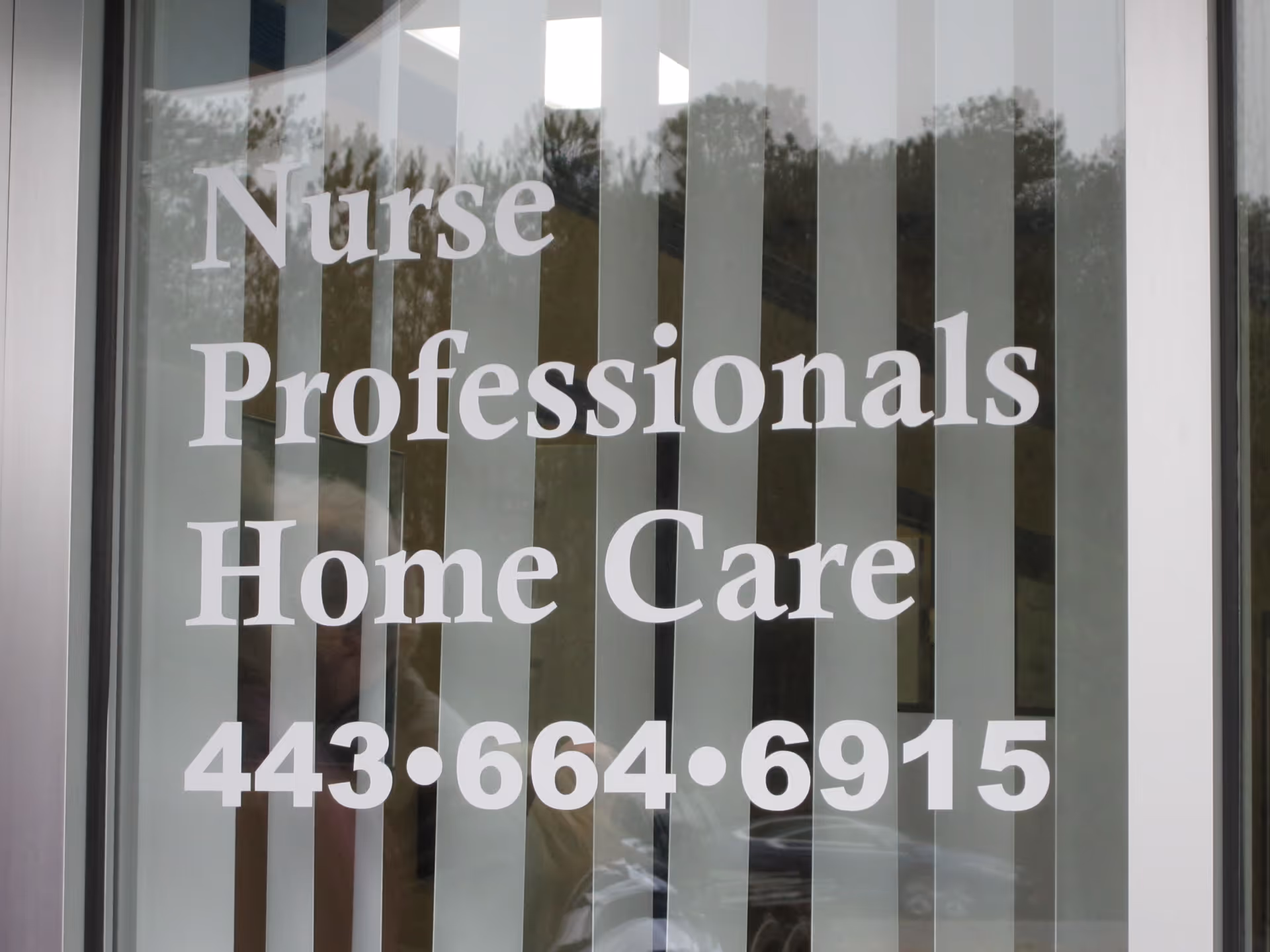 Front window sign reading Nurse Professionals Home Care with phone number