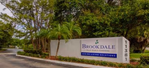 Exterior view of Brookdale Palm Beach Gardens sign by entrance landscaping