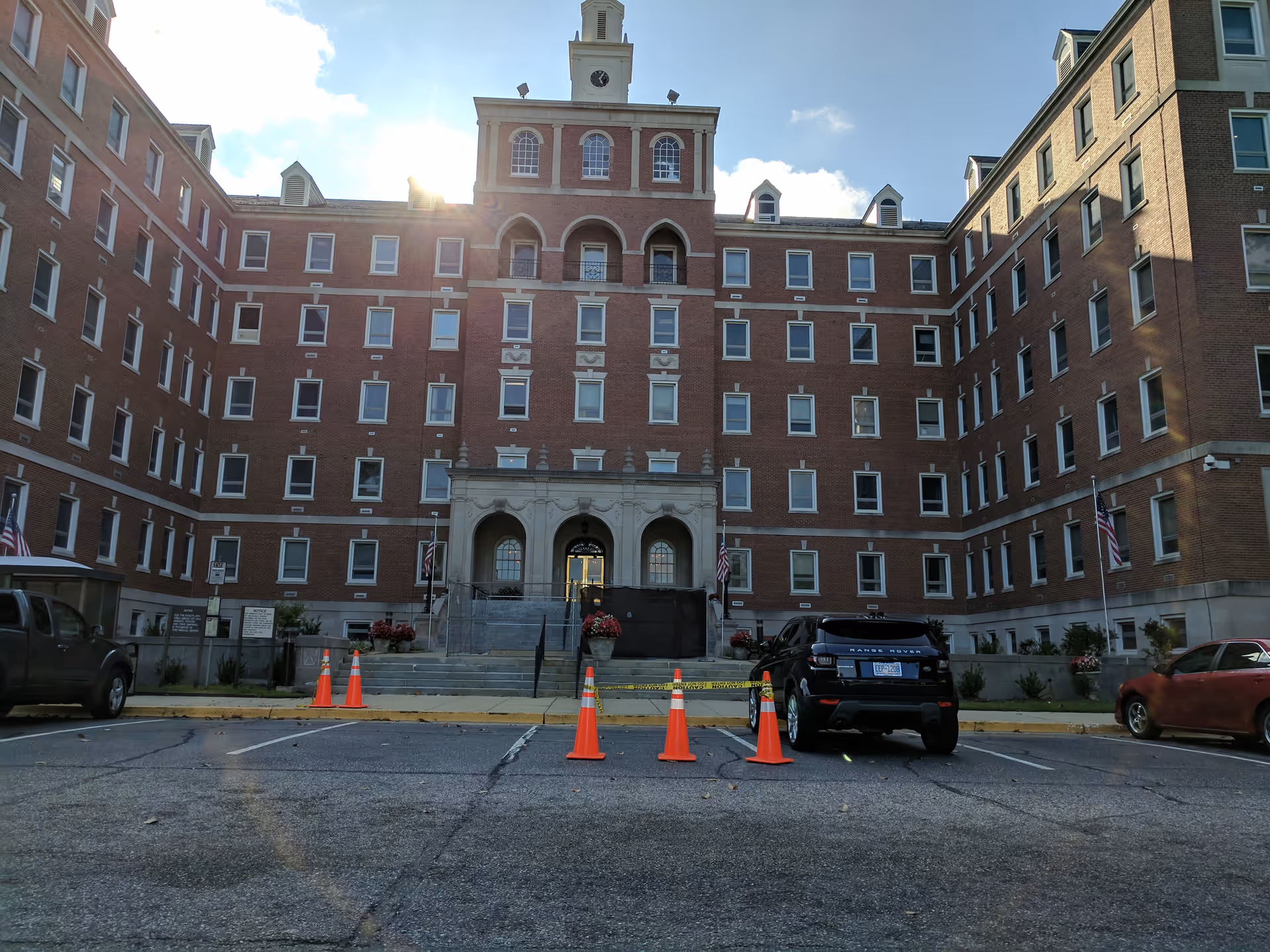 Brick Fayetteville VA Medical Center building viewed from parking lot with traffic cones.