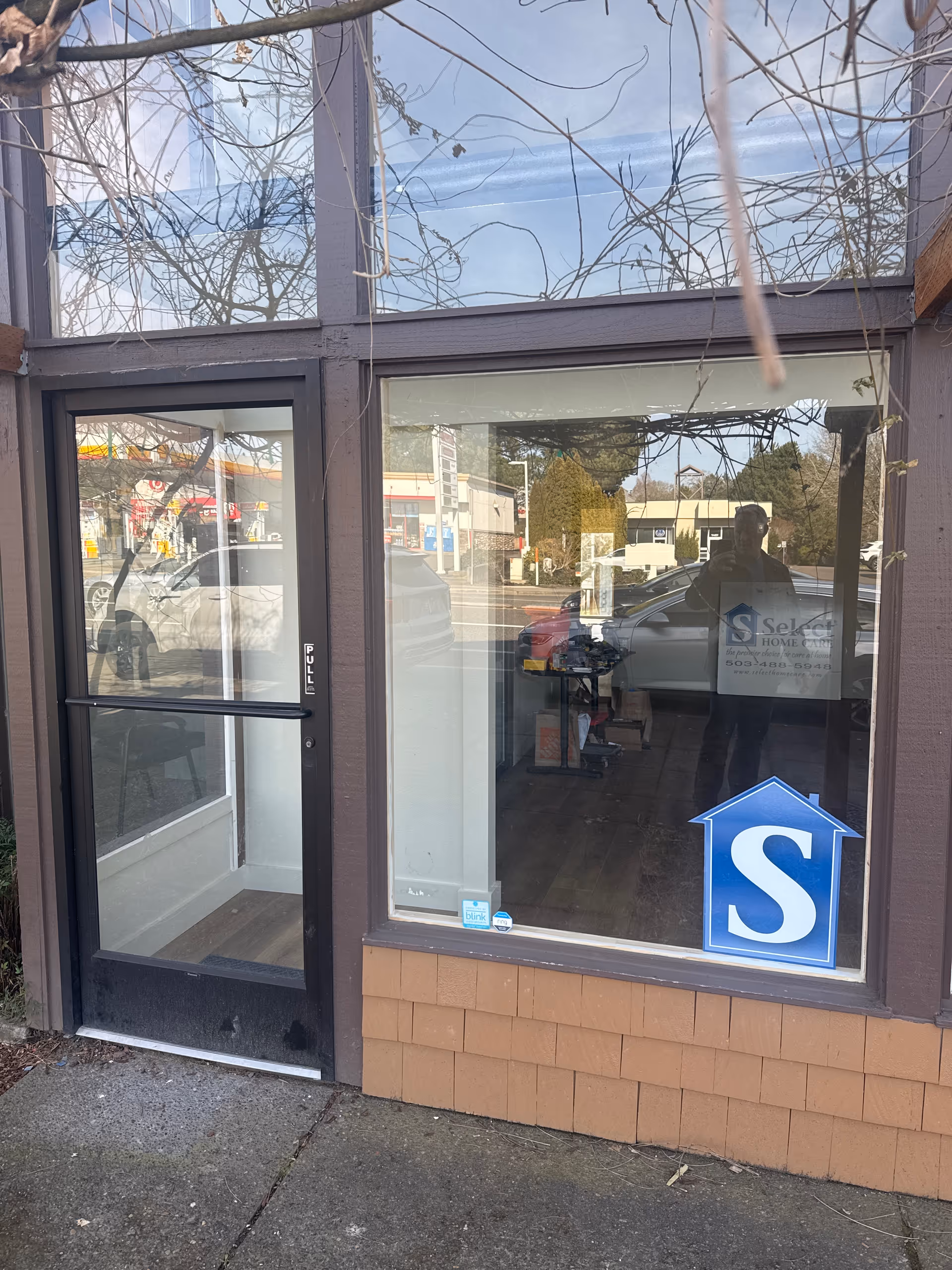 Exterior view of Select Home Care Portland storefront with glass door and window.