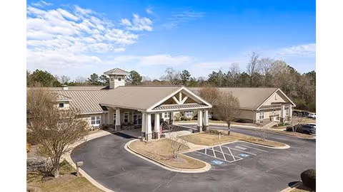 Front view of Benton House of Covington, a single-story facility with entrance canopy and parking.