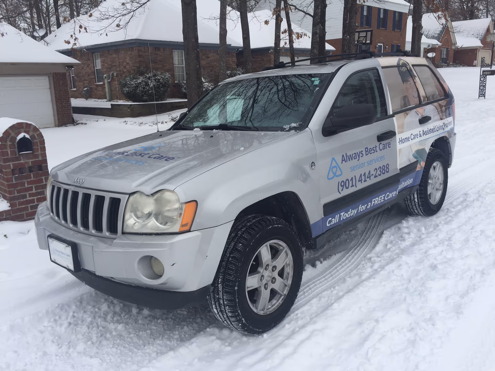 Branded white van for Always Best Care Home Care parked on a snowy residential street.