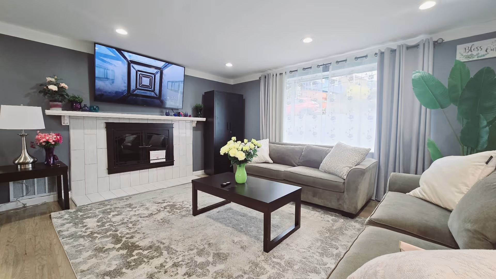 Cozy living room at Gentle Groove Adult Family Home with couches, fireplace, and TV.