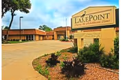 Exterior view of LakePoint El Dorado facility with sign and landscaped entrance