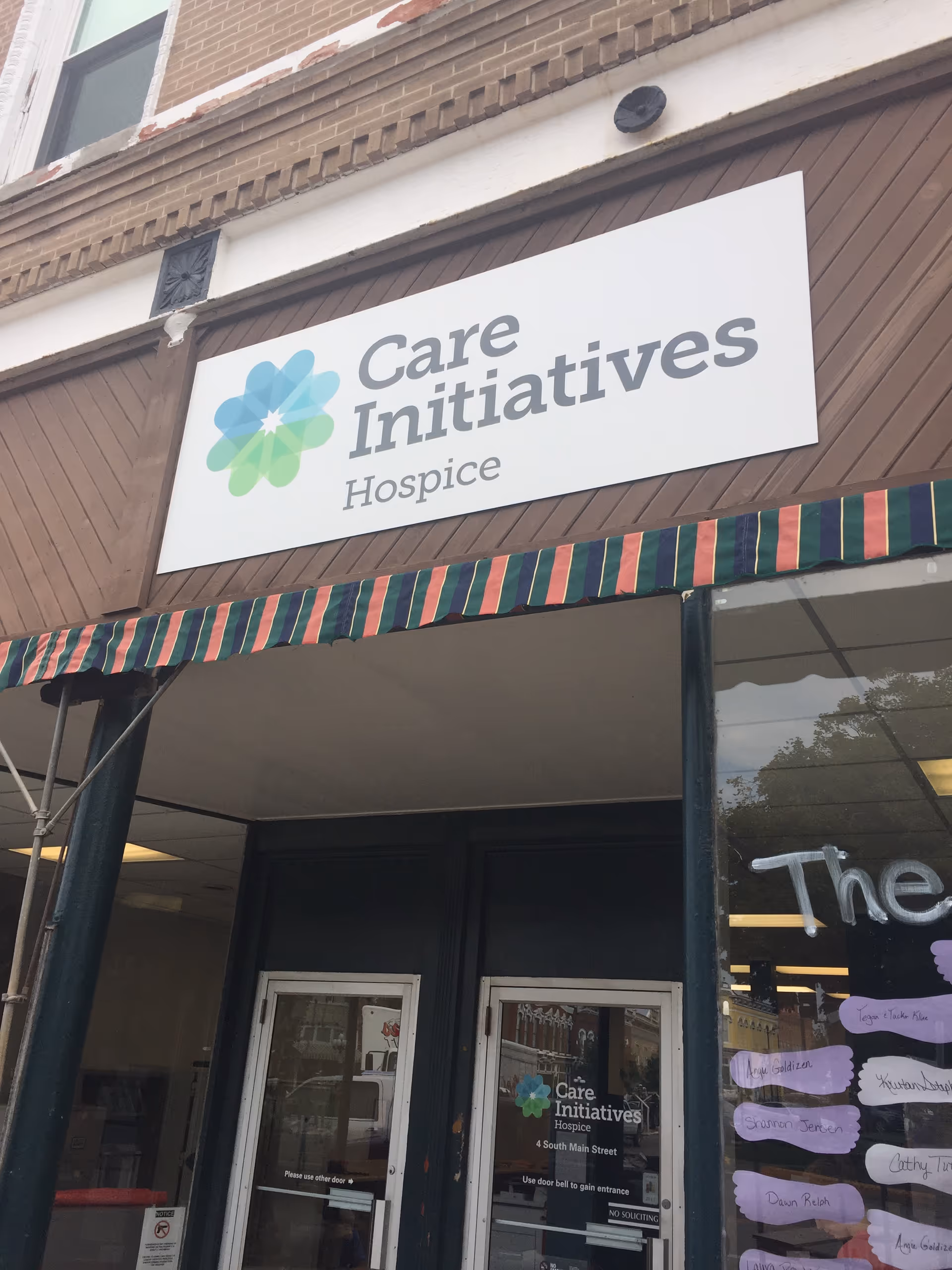 Exterior storefront of Care Initiatives Hospice with a large sign above entrance.
