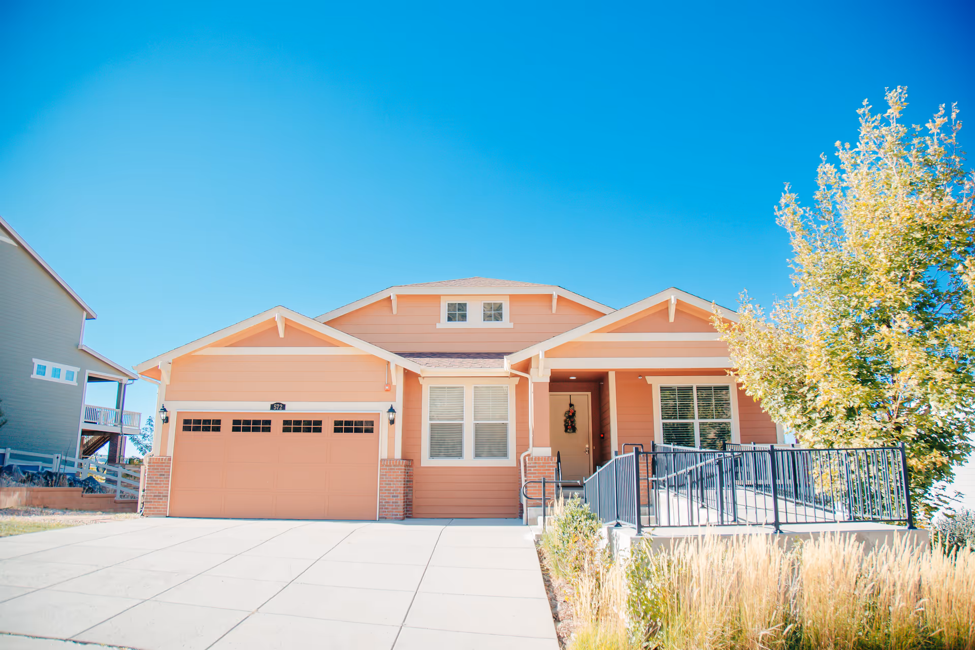 Peach-colored single-story facility exterior with a two-car garage and front entrance.