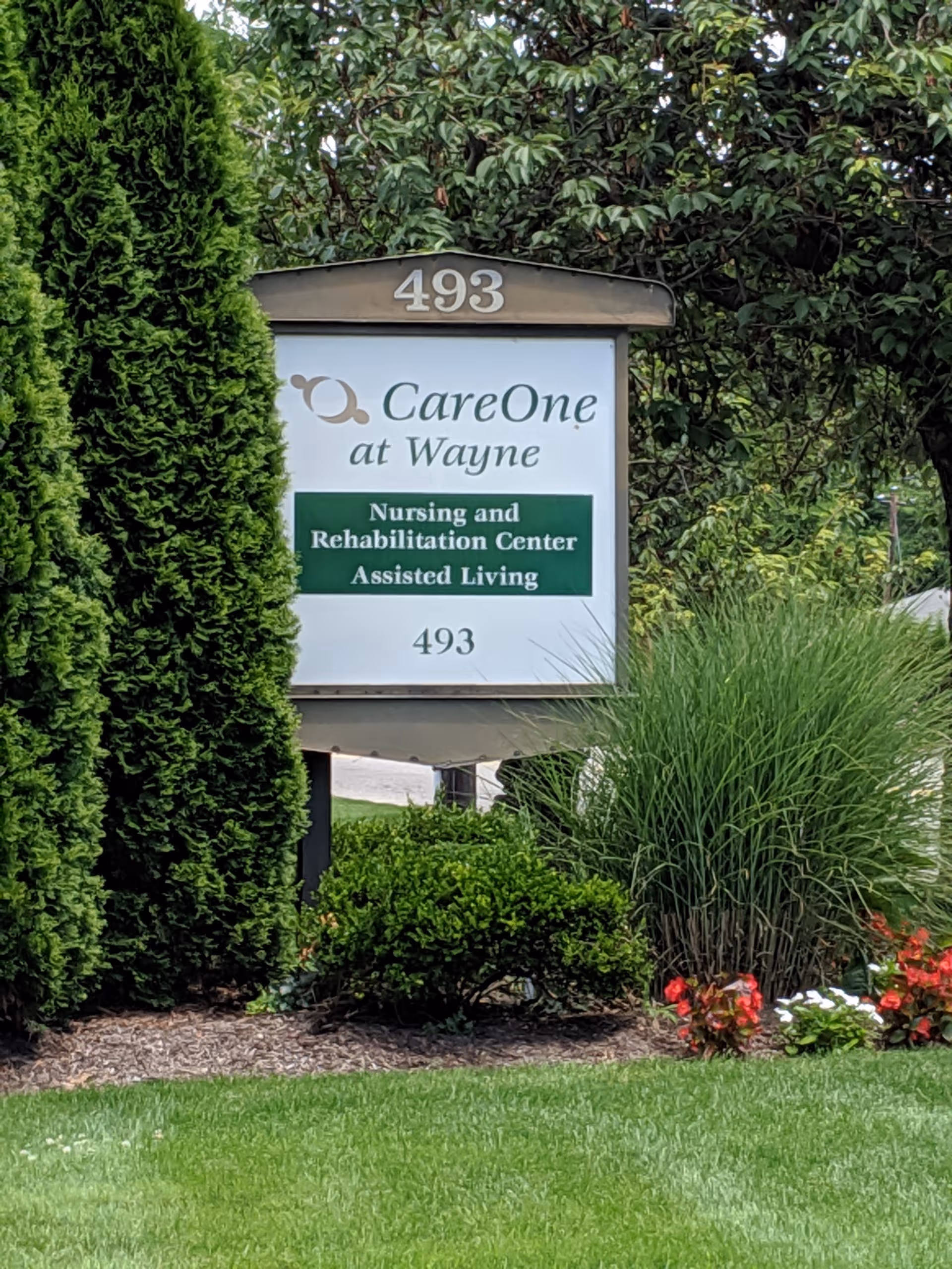 CareOne at Wayne sign for Nursing and Rehabilitation Center amid a landscaped front yard