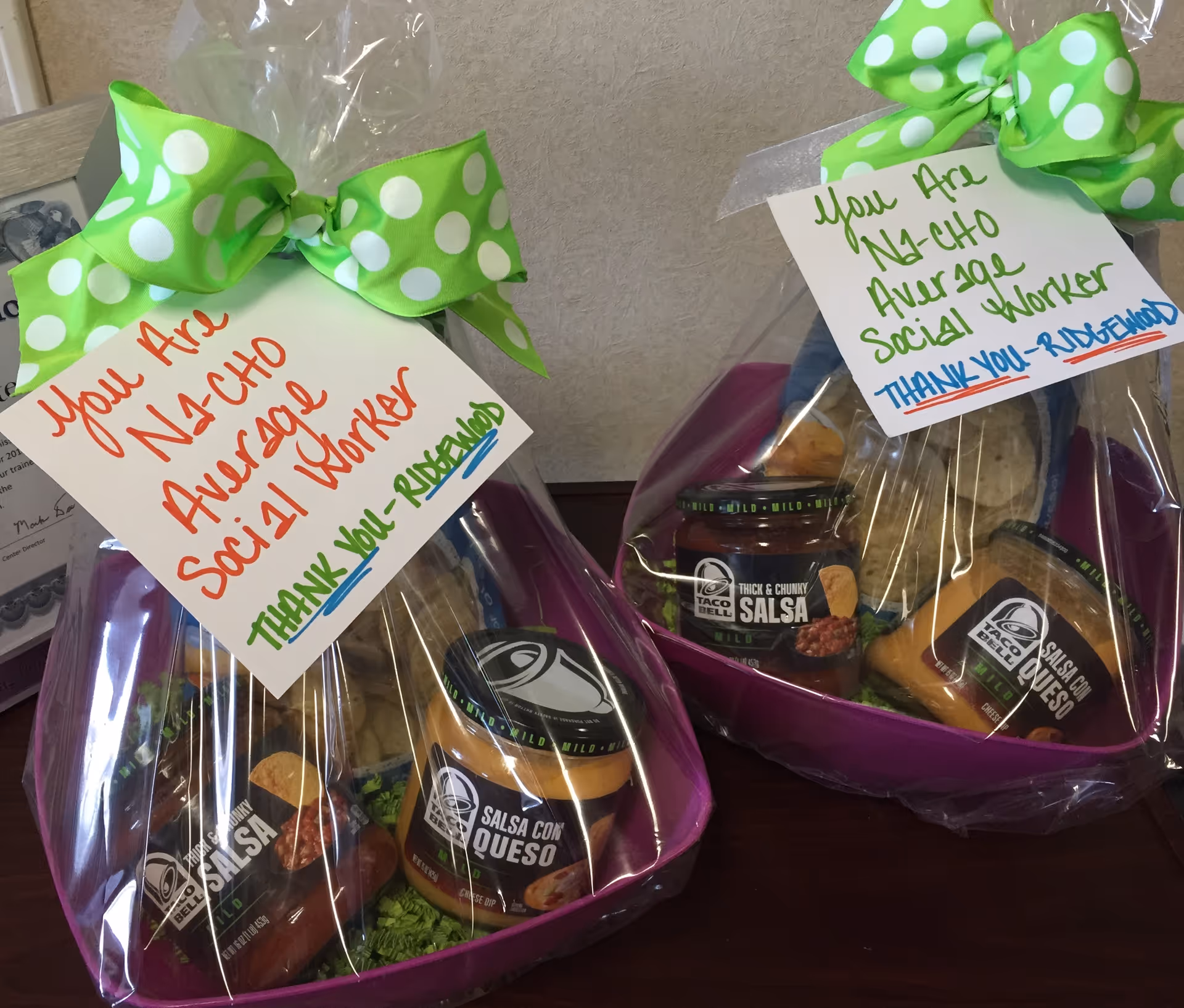Two gift baskets with salsa jars, wrapped in plastic, green polka-dot ribbons, Ridgewood tags.