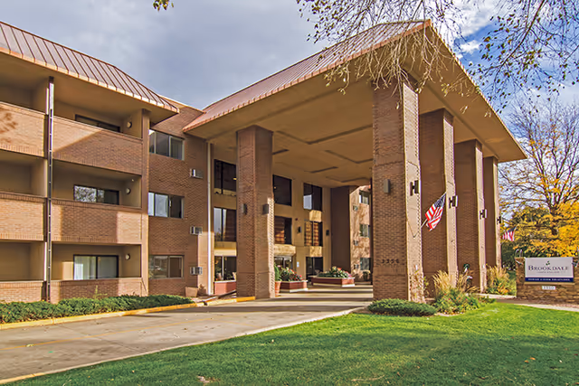 Exterior view of Brookdale North Boulder, a brick senior living facility with a covered entrance.