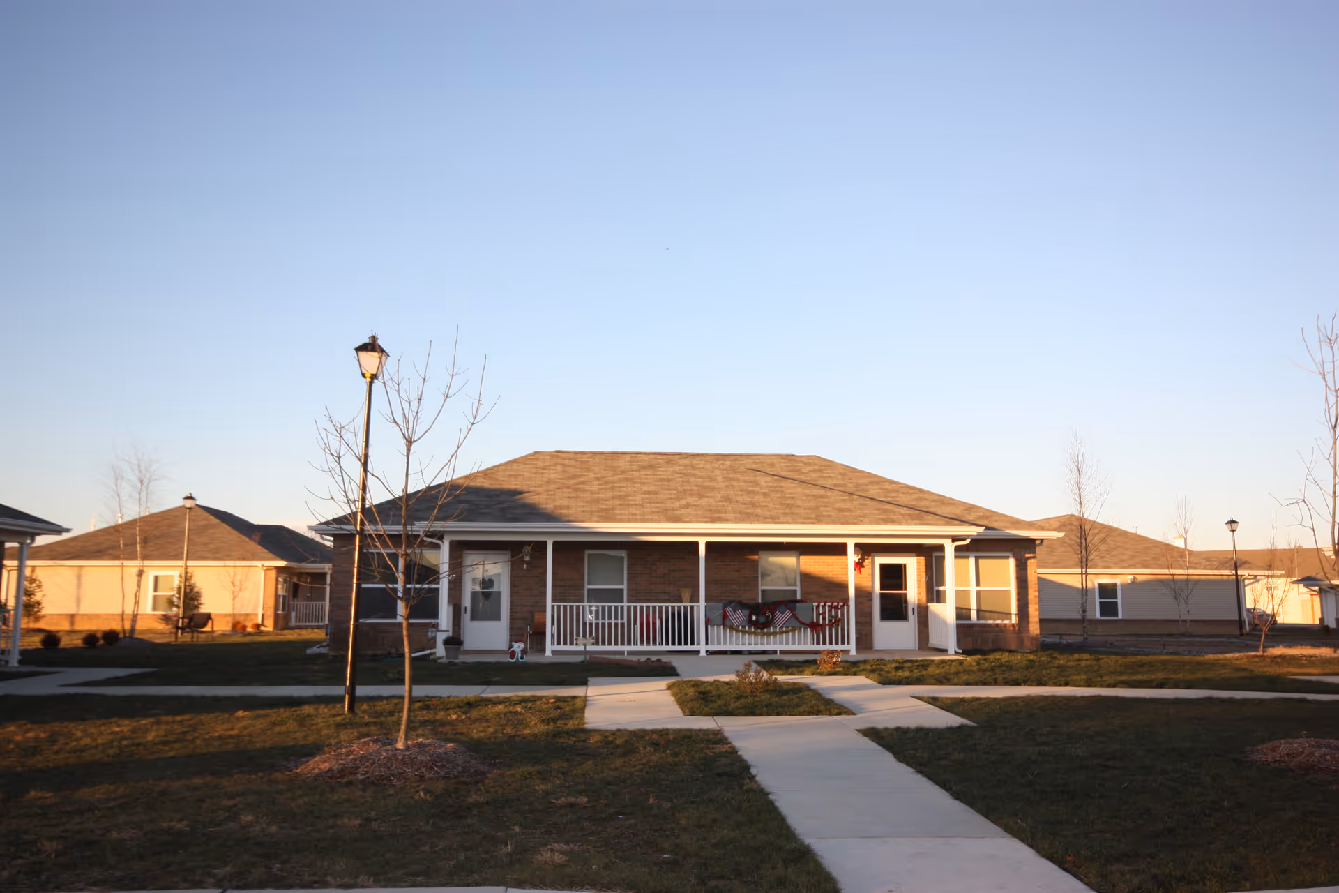 One-story brick building with a covered front porch and walkway.