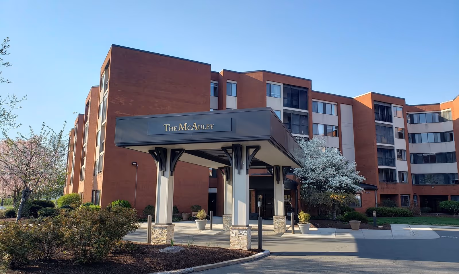 Exterior view of The McAuley entrance under a covered porte-cochere