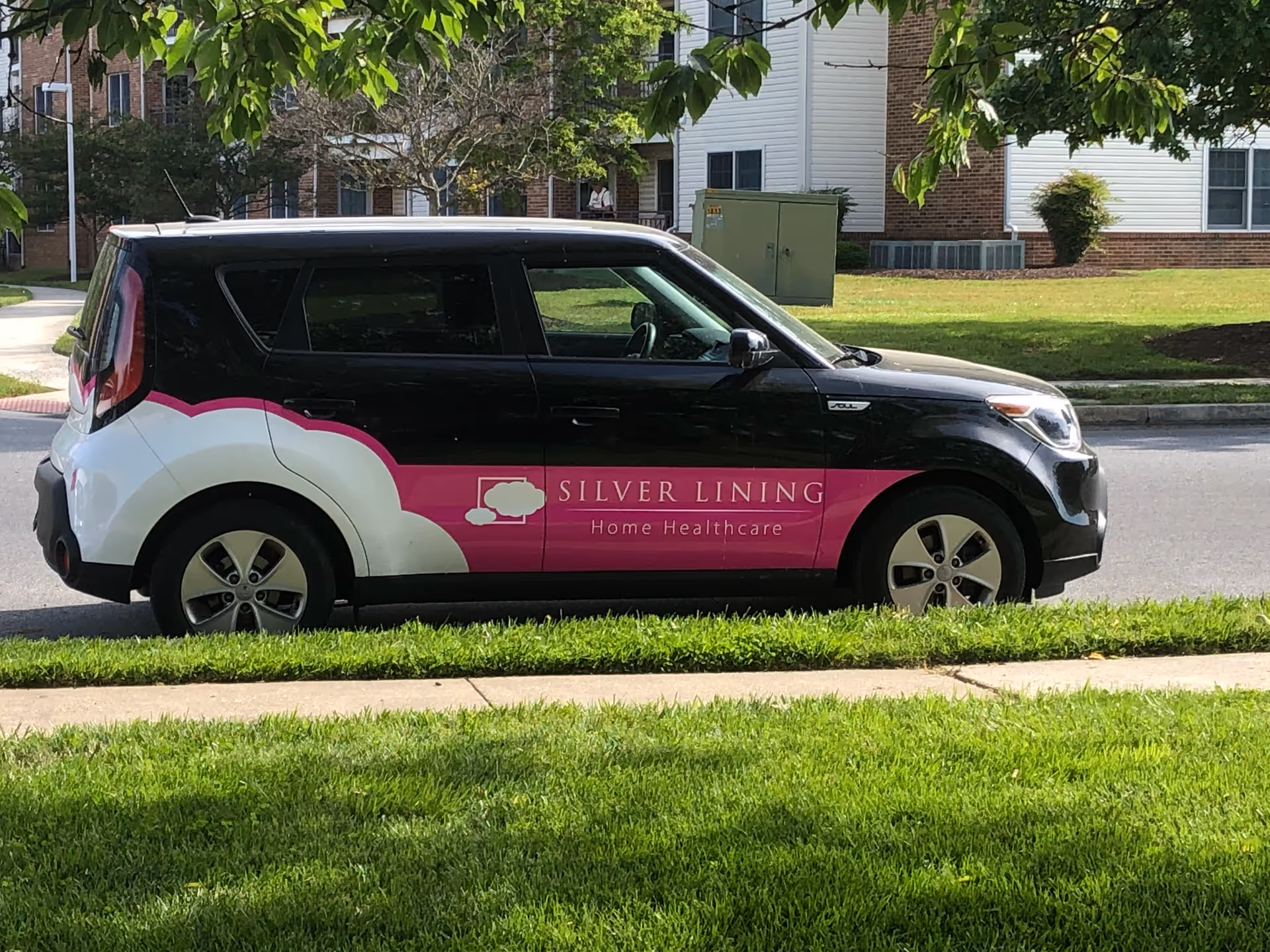 Branded Silver Lining Home Healthcare van parked along a residential street.