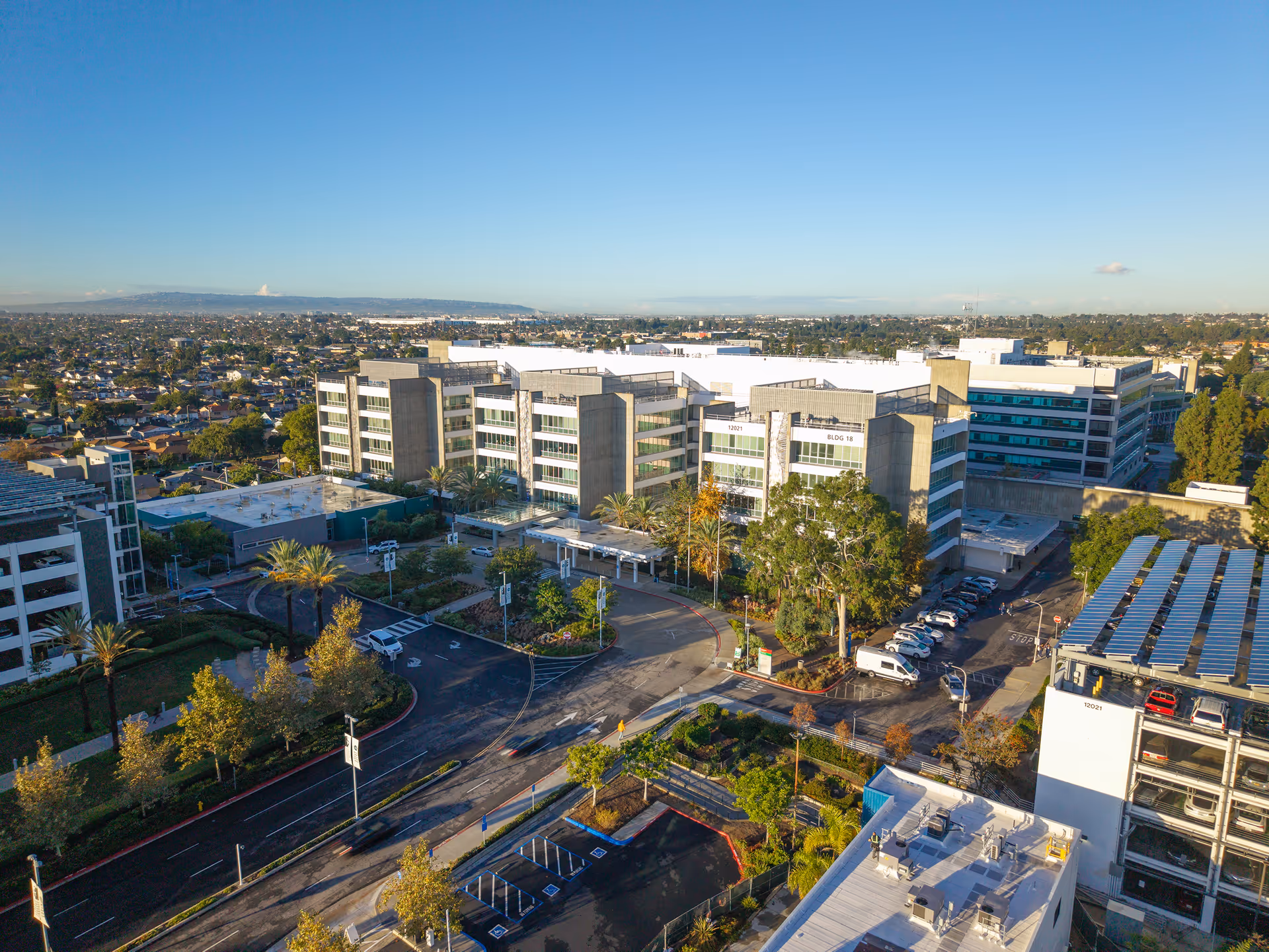 Aerial view of a multi-building senior care campus with parking and surrounding streets