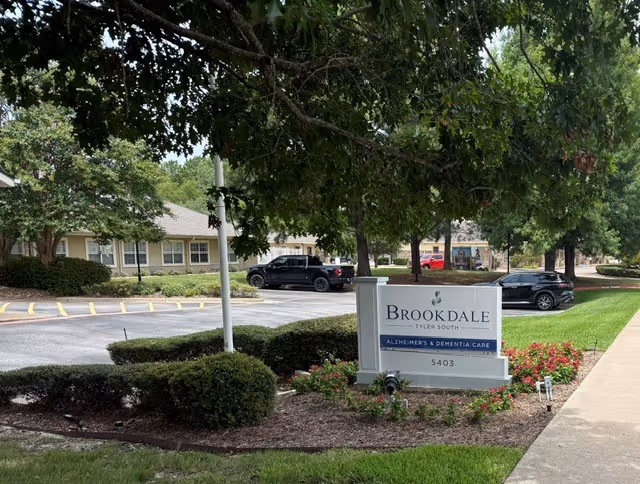 Exterior view of a Brookdale senior living facility with a front sign and parking.