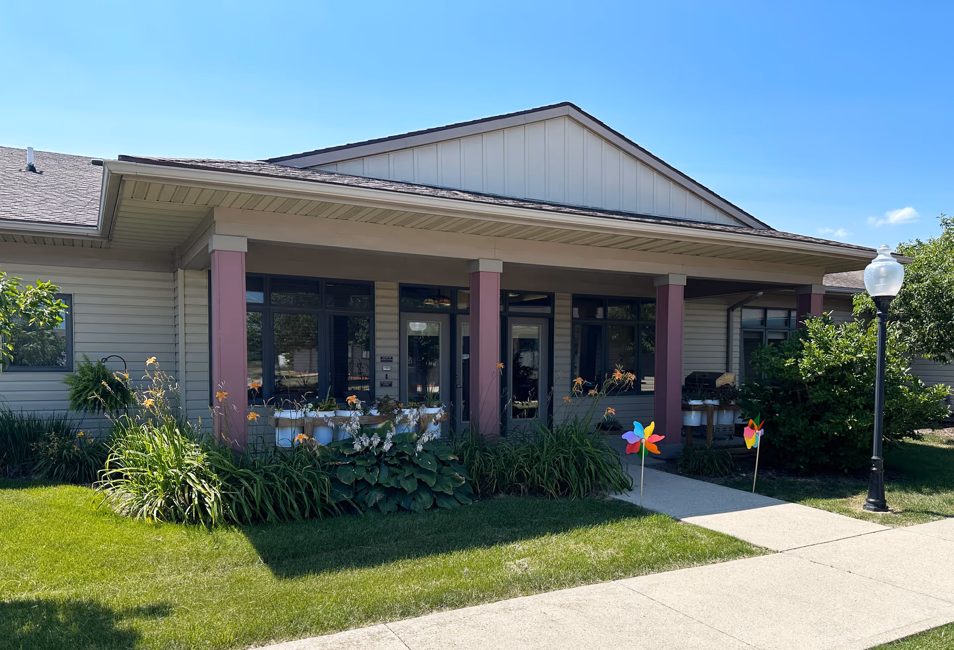 Southfield Wellness Community front entrance with purple columns, landscaping, and a lamp post.