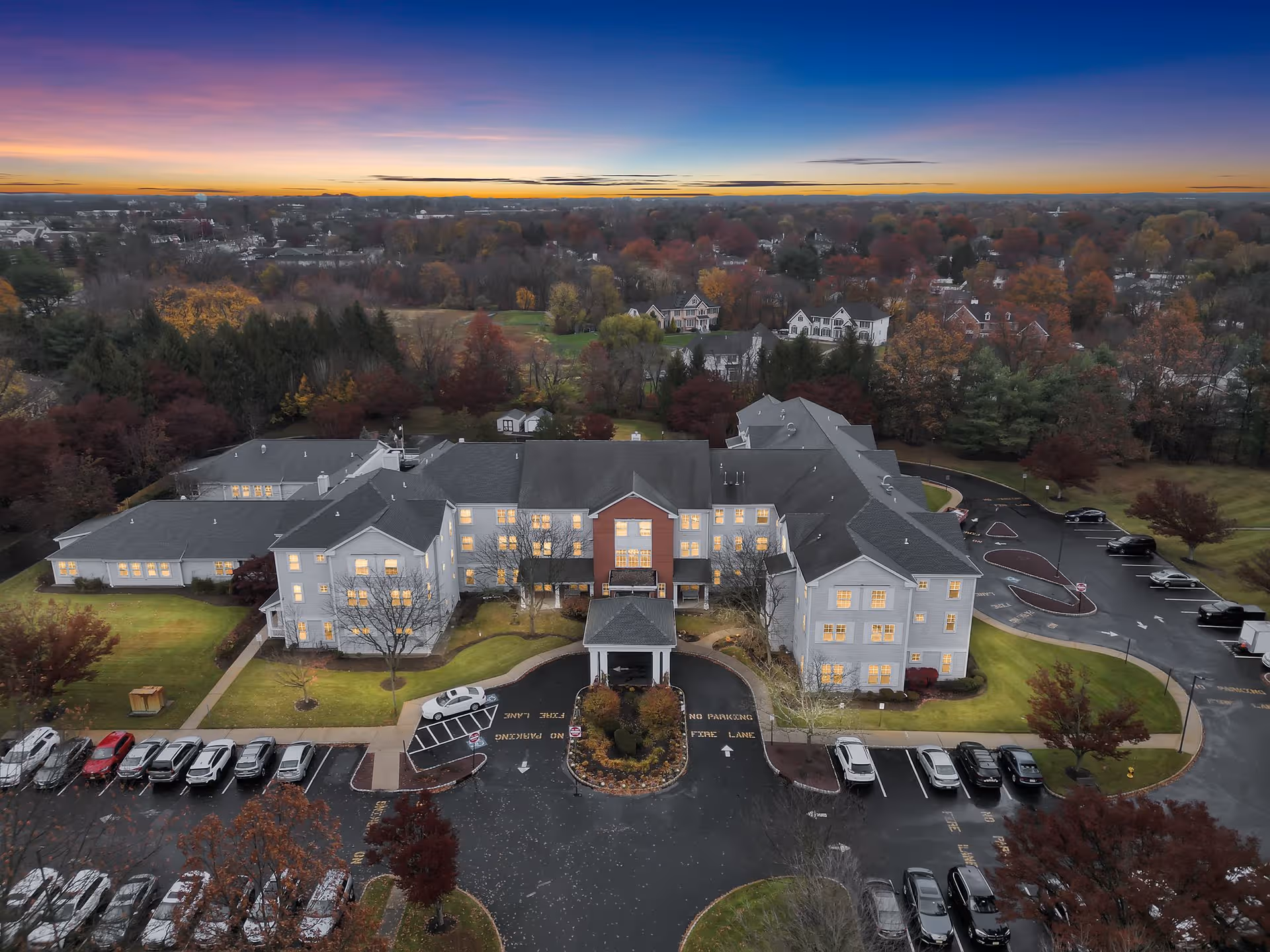 Aerial view of Monmouth ALF, a large senior living facility with a circular driveway and parking.