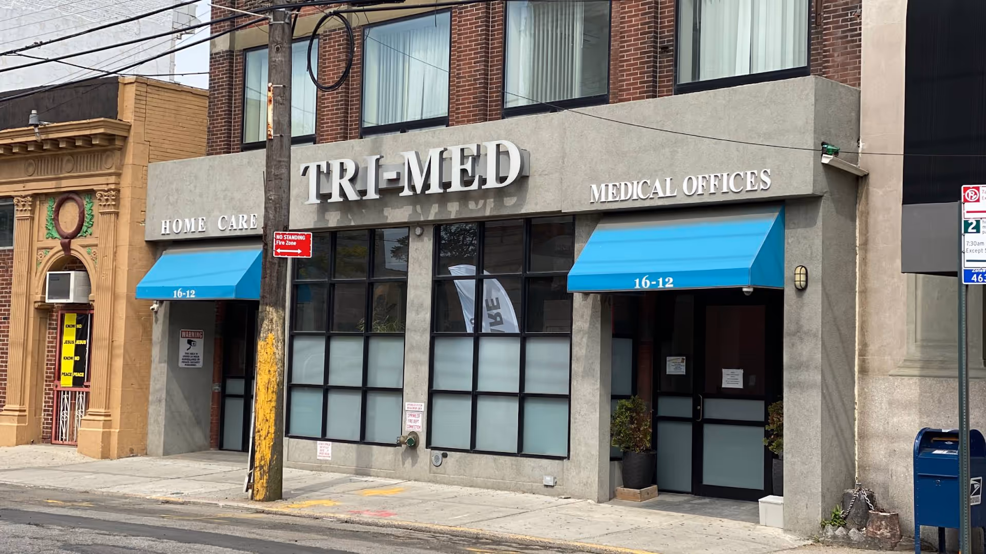 Street-level view of TRI-MED Home Care Services storefront with blue awnings.