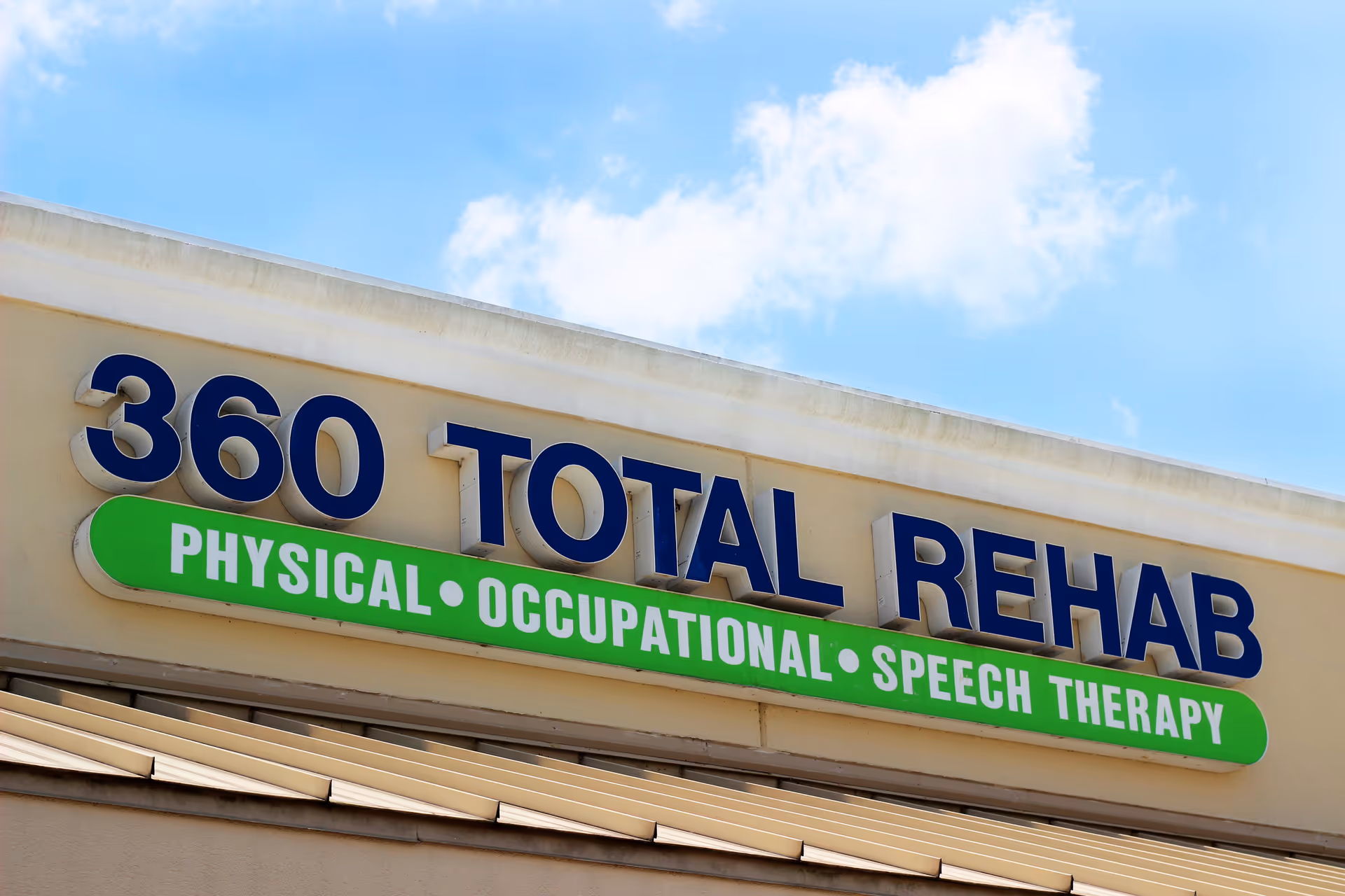 Exterior of the 360 Total Rehab building with a green therapy sign.