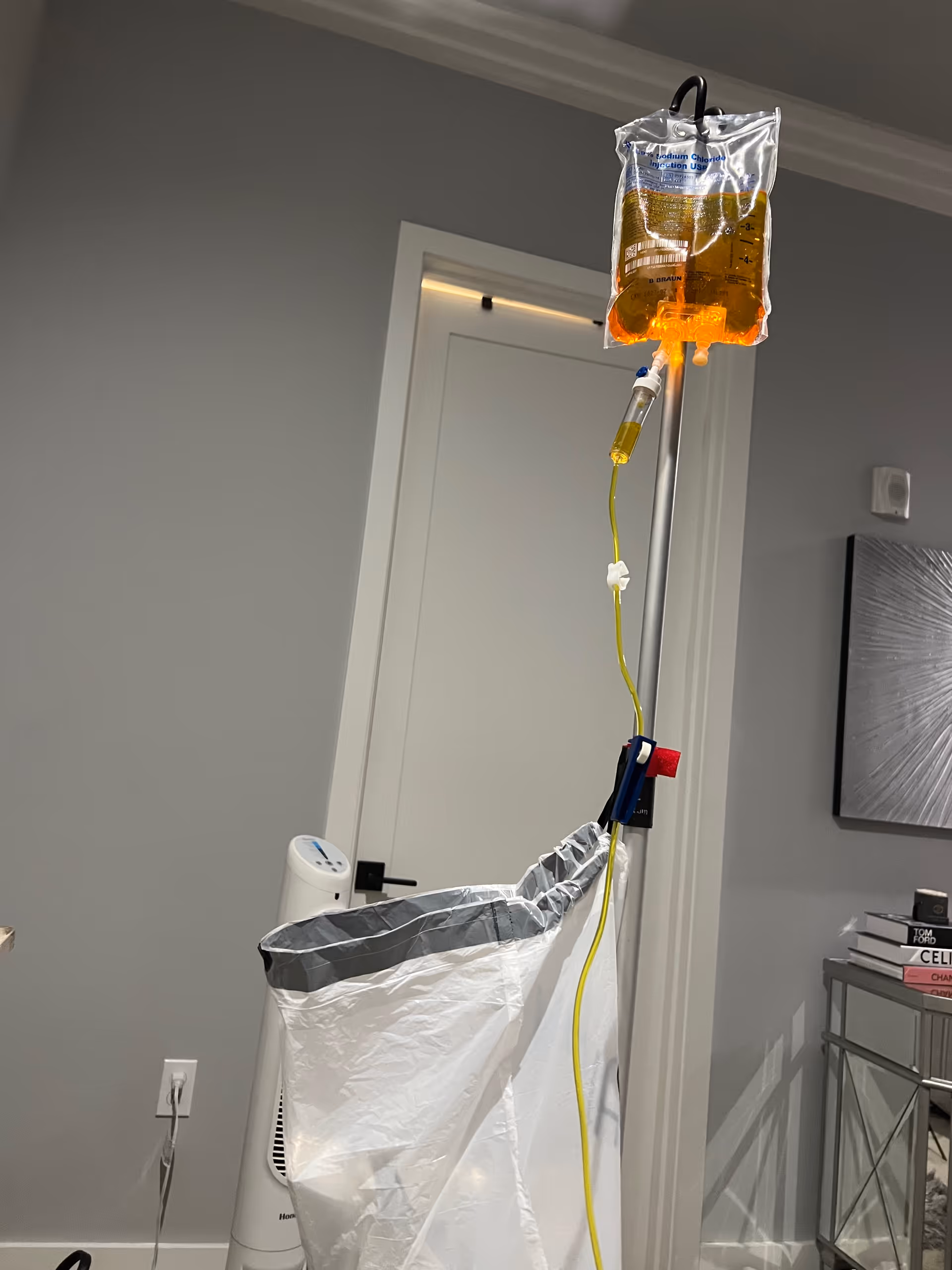 IV infusion bag and pole in a modern senior living room