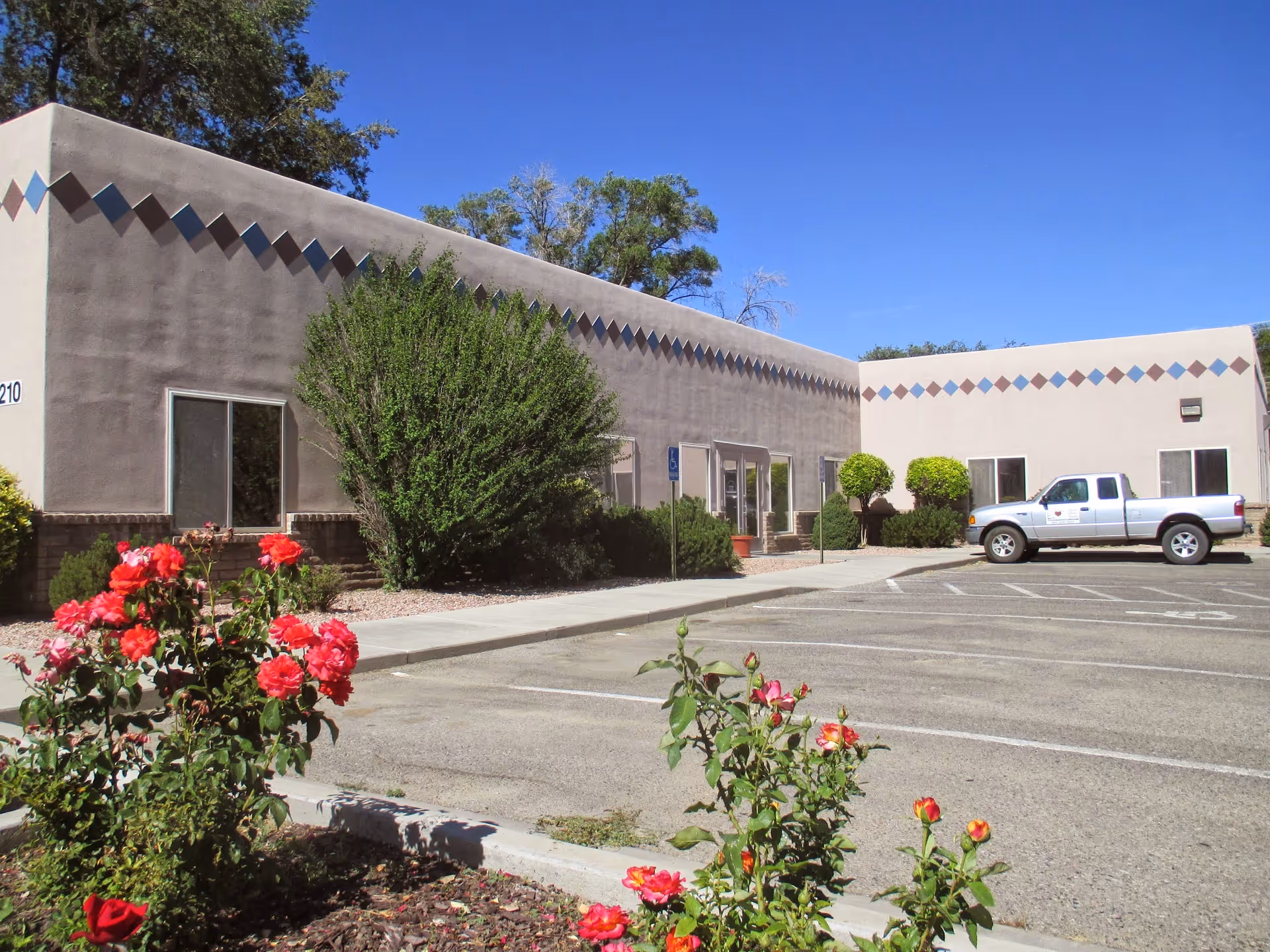 Exterior view of Basin Coordinated HealthCare Farmington facility front with parking lot and landscaping.