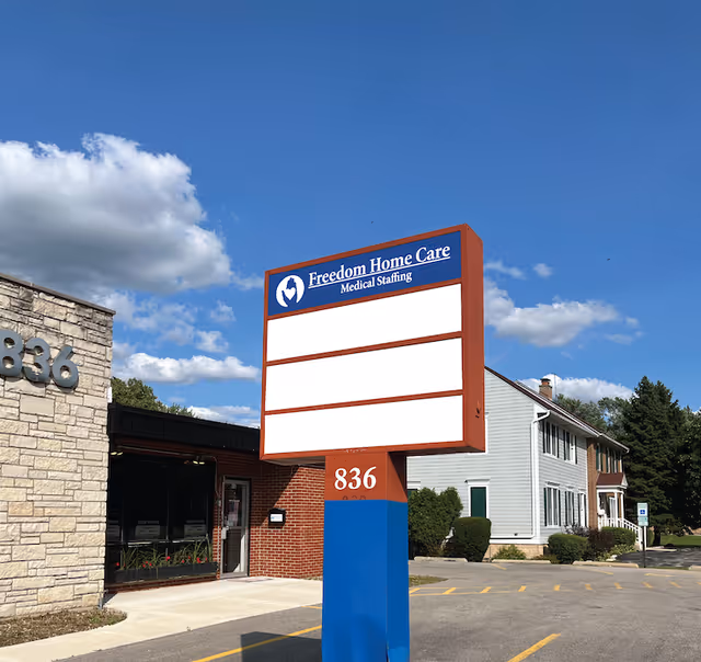 Exterior view of Freedom Home Care sign and building at 836 under a blue sky