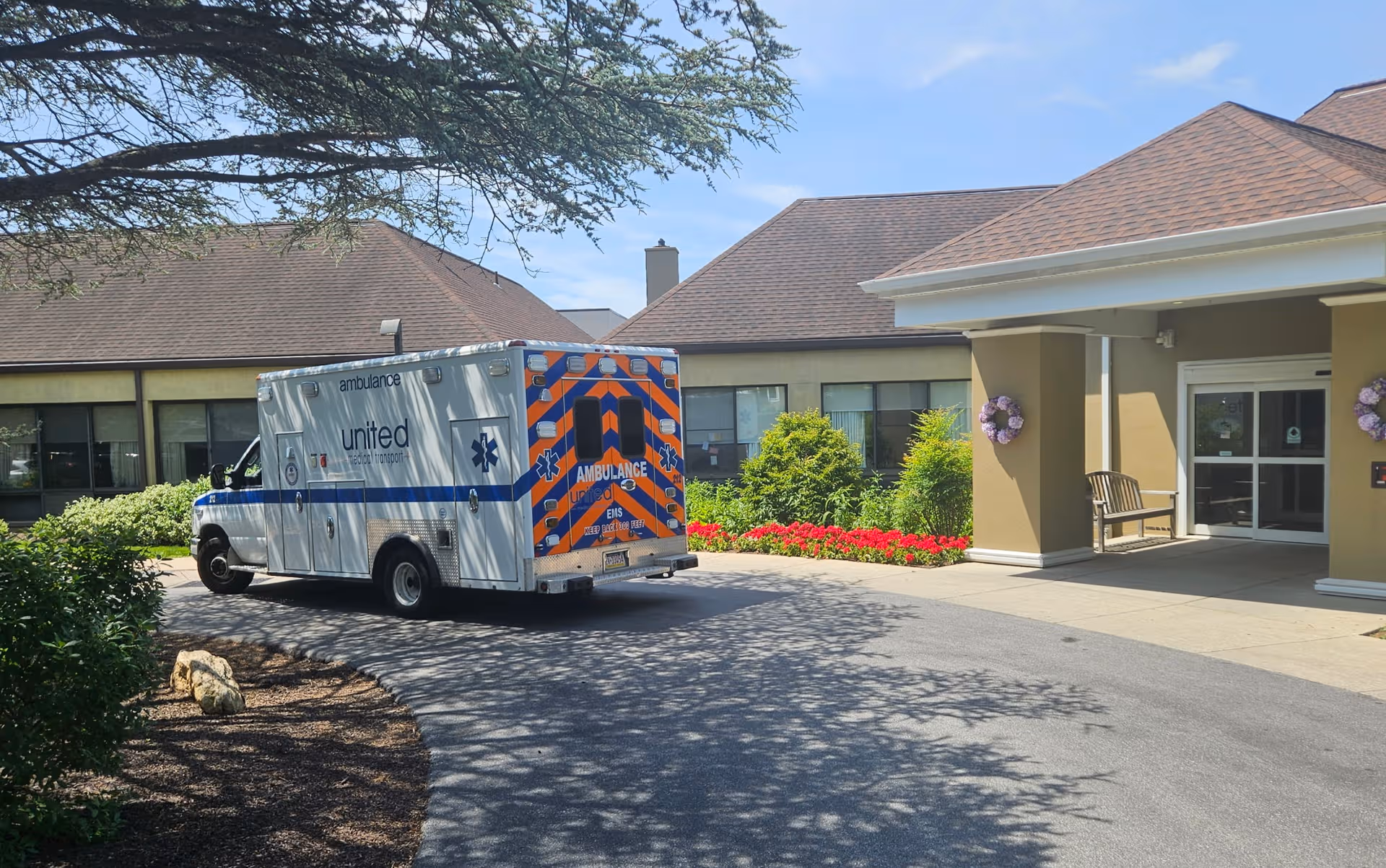 Ambulance parked at Dunwoody Village front entrance of a senior living facility.