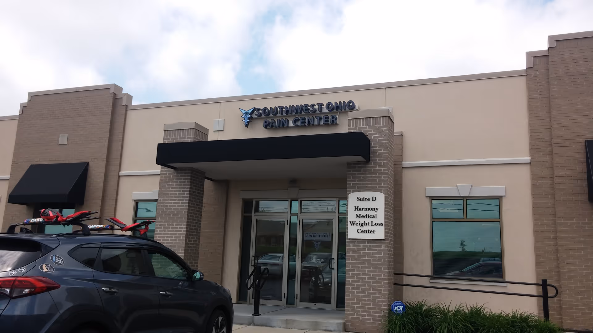 Front view of Southwest Ohio Pain Center entrance with glass doors.