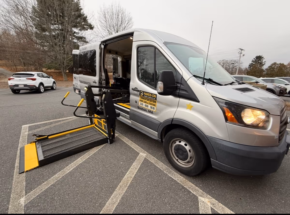 Exterior view of Hands-on America Services van with wheelchair ramp in a parking lot.