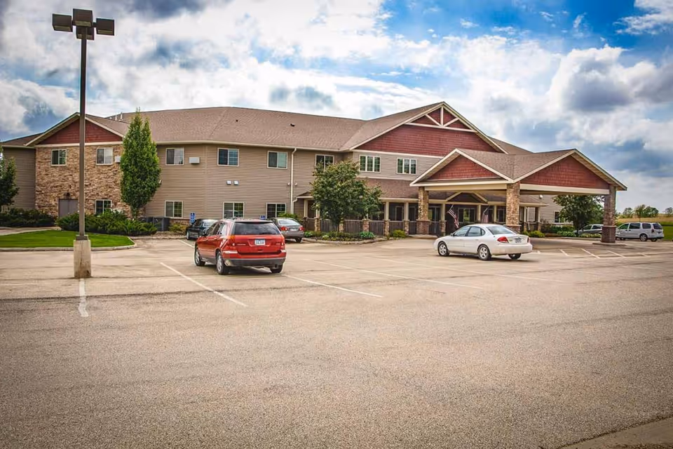 Exterior view of Copper Creek Senior Living building with a covered entrance and parking lot.