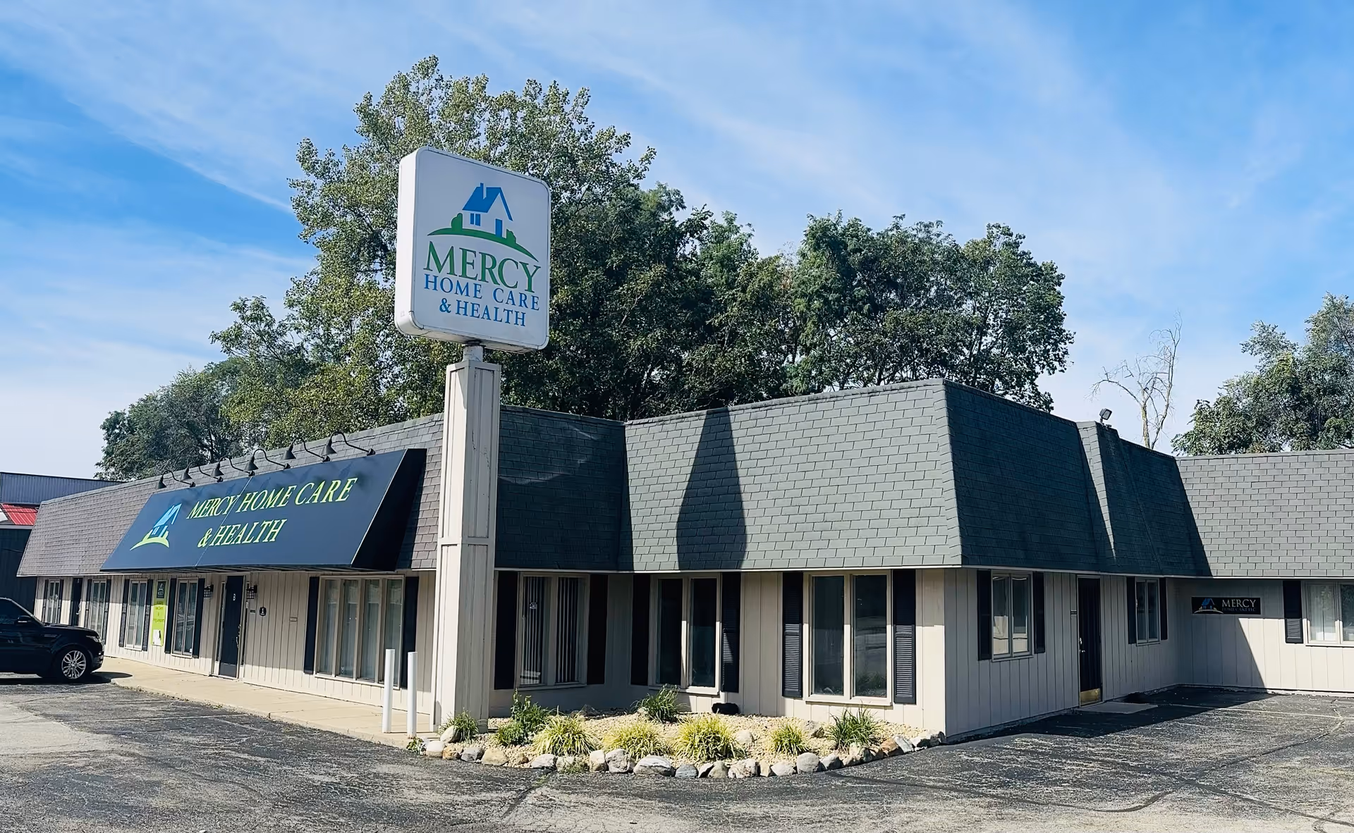 Exterior view of Mercy Home Care & Health with a tall sign and parking lot.