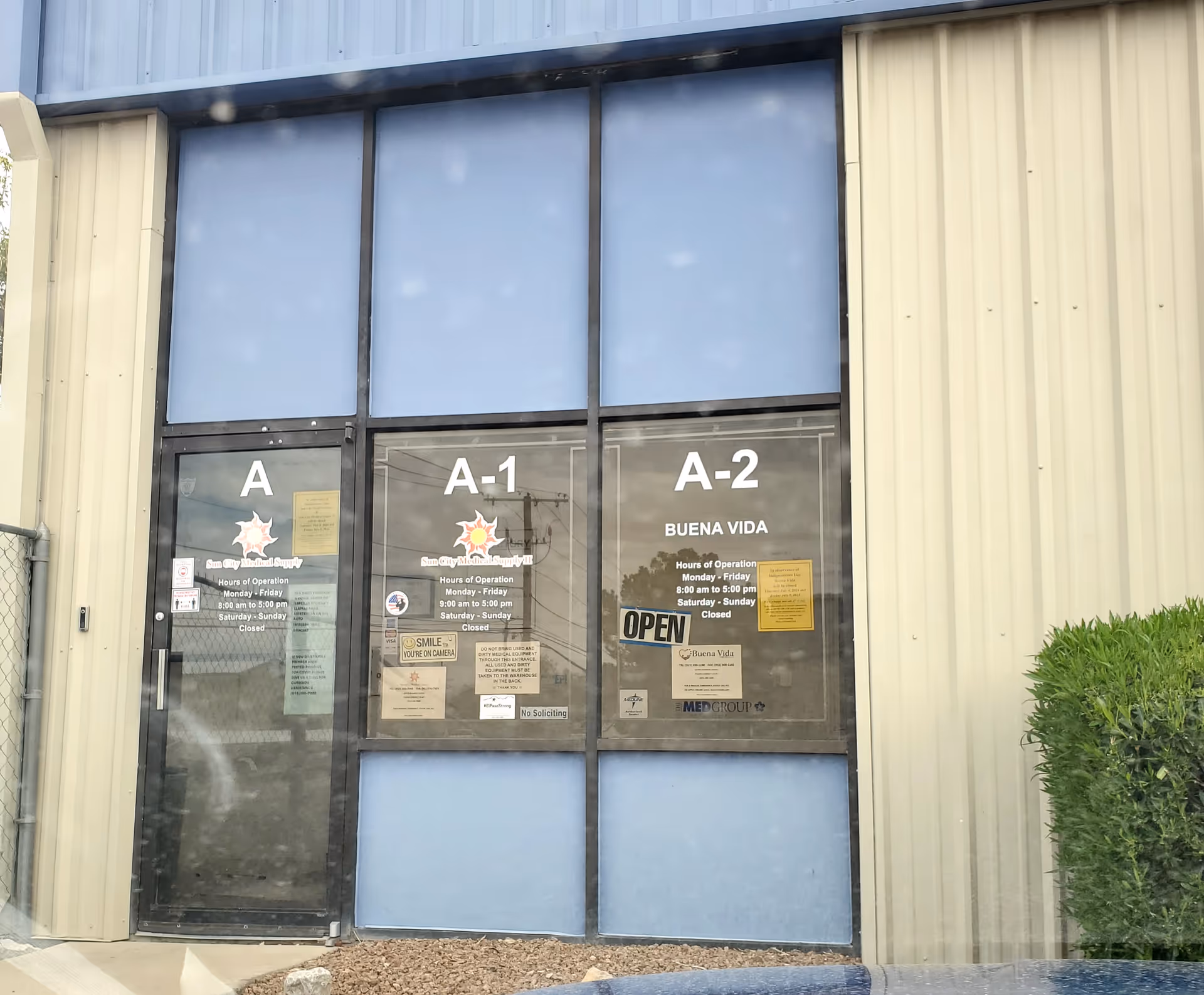 Front entrance of Buena Vida Home Health building with glass doors labeled A-1 and A-2