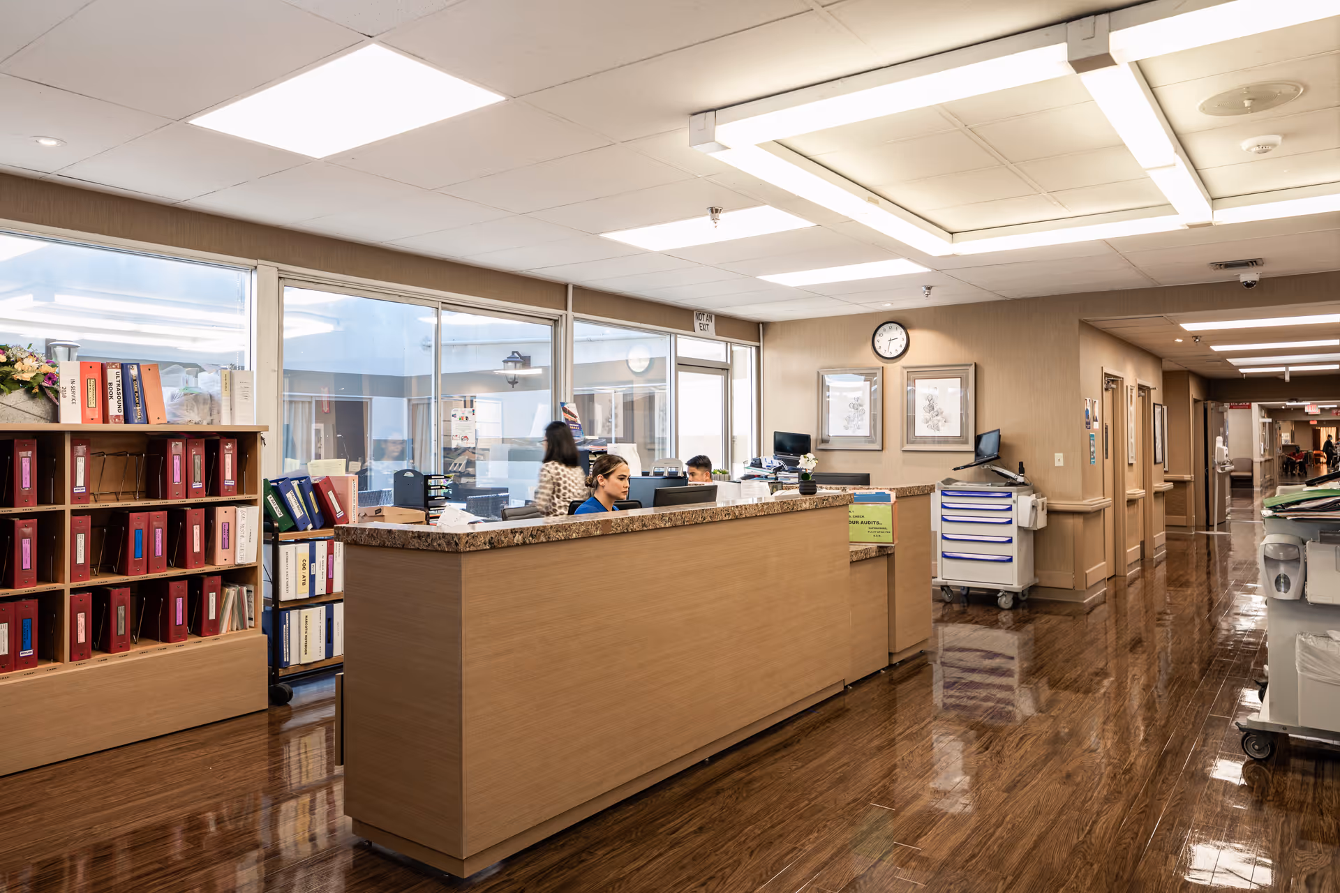 Reception desk area in a senior living facility with staff at the counter.